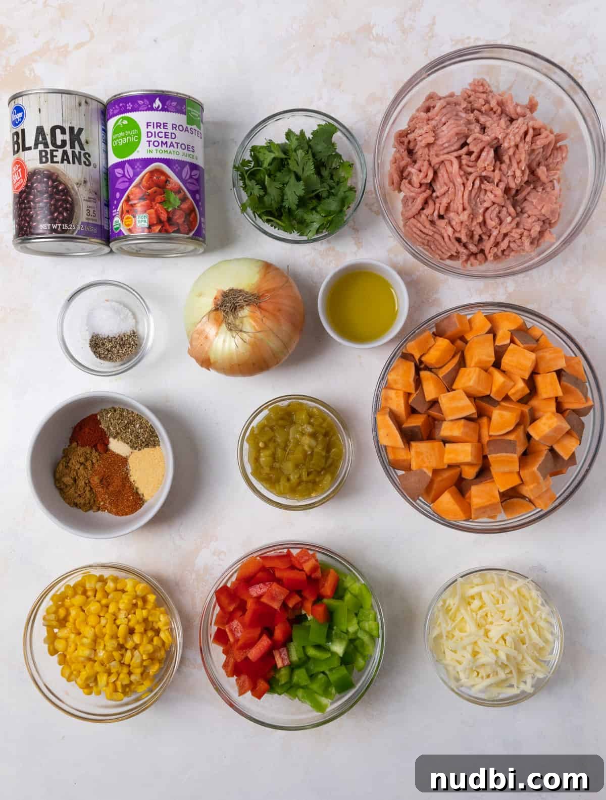 One-Pan Ground Turkey and Sweet Potato Skillet Recipe 4 Ground turkey, beans, tomatoes, bell pepper and other recipe ingredients on counter.