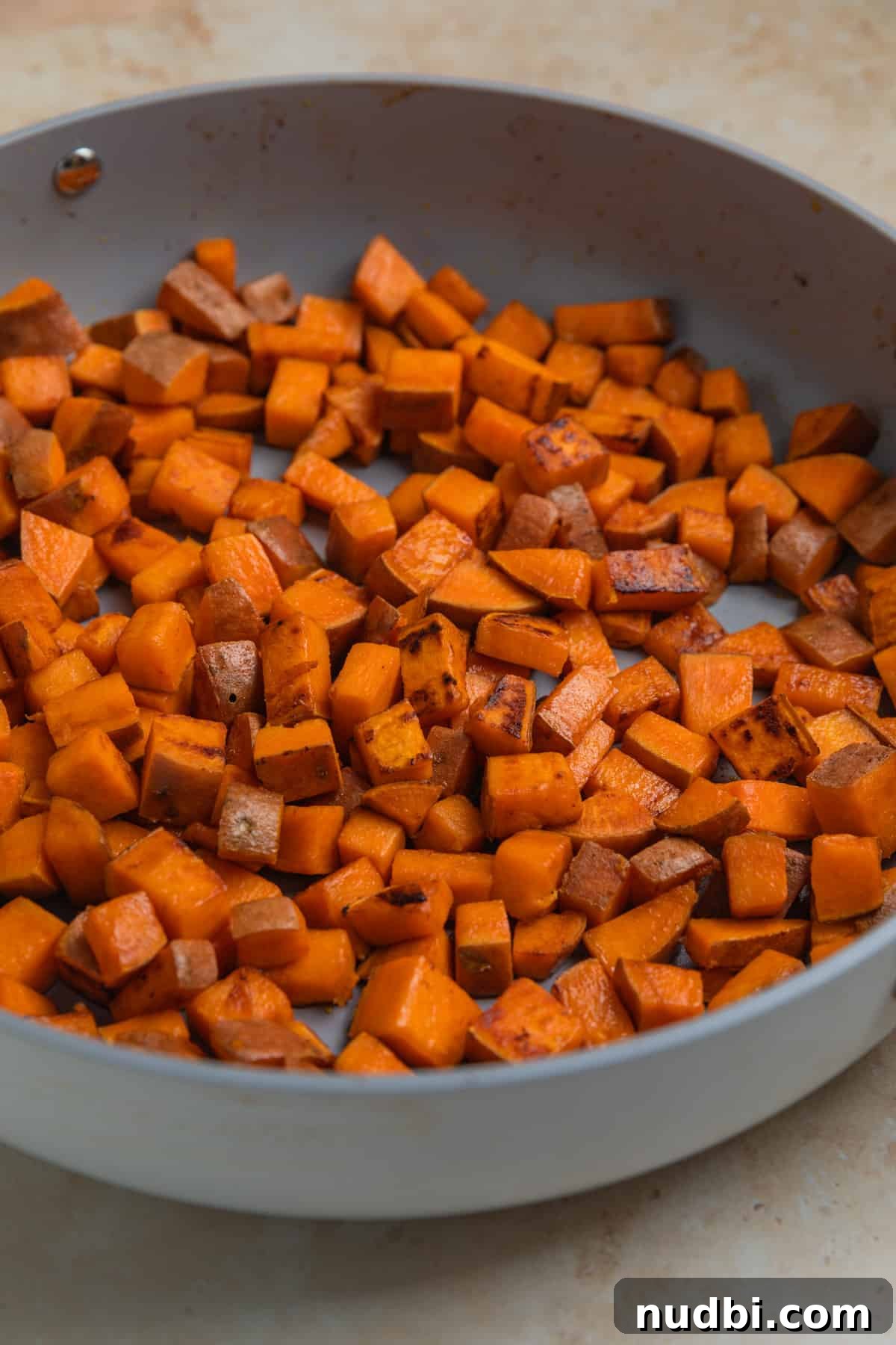 One-Pan Ground Turkey and Sweet Potato Skillet Recipe 6 Sweet potatoes cooked in an even layer in skillet.