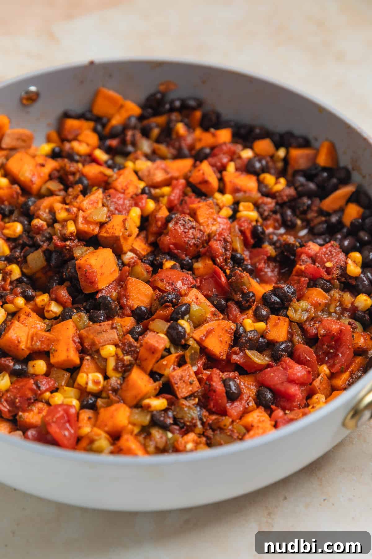 One-Pan Ground Turkey and Sweet Potato Skillet Recipe 8 Skillet dinner ingredients in pan combined.