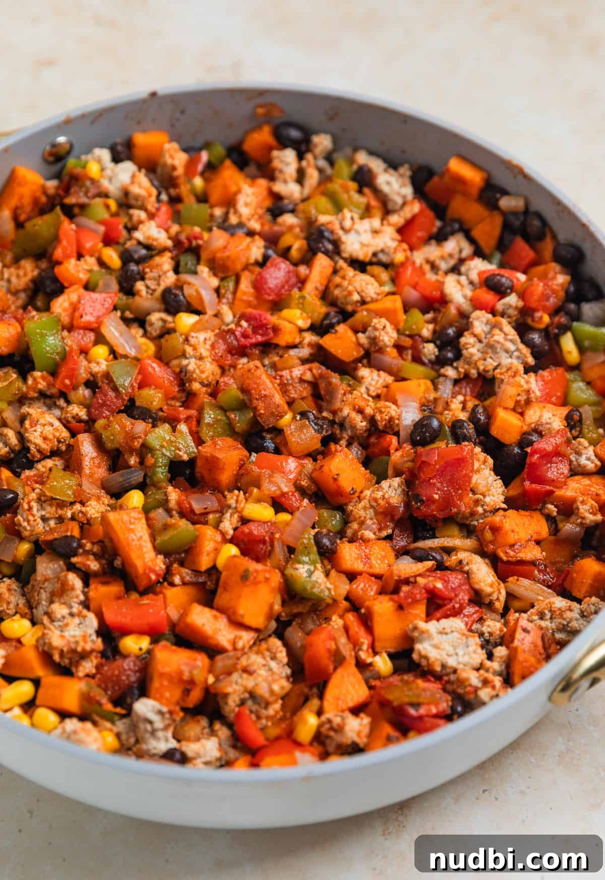 One-Pan Ground Turkey and Sweet Potato Skillet Recipe 9 Turkey and pepper mixture stirred into sweet potato, bean, corn mixture in skillet.