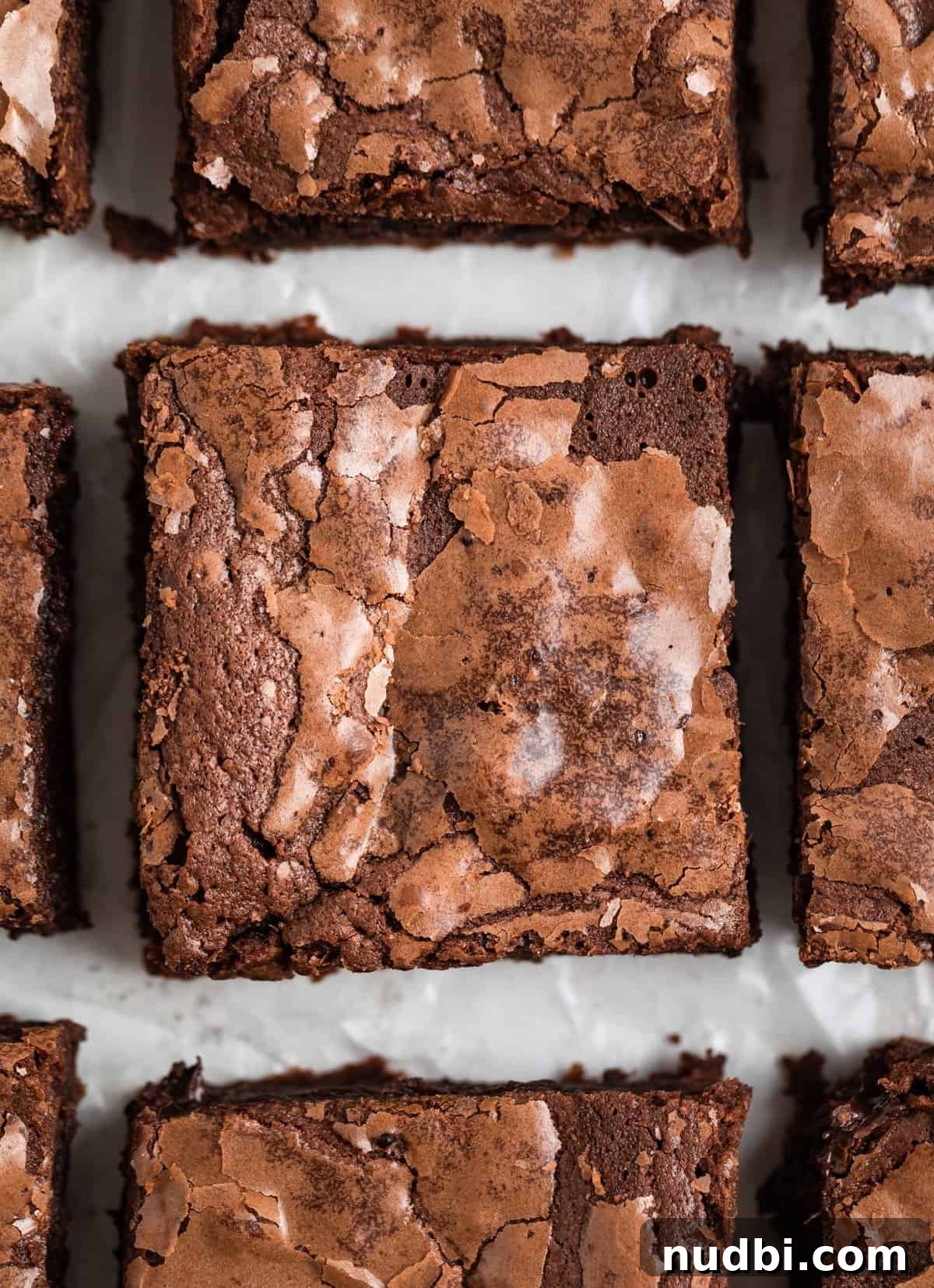 Fudgy Condensed Milk Brownies Recipe with Glossy Caramel Top 2 Condensed brownies sliced and lined up on parchment.