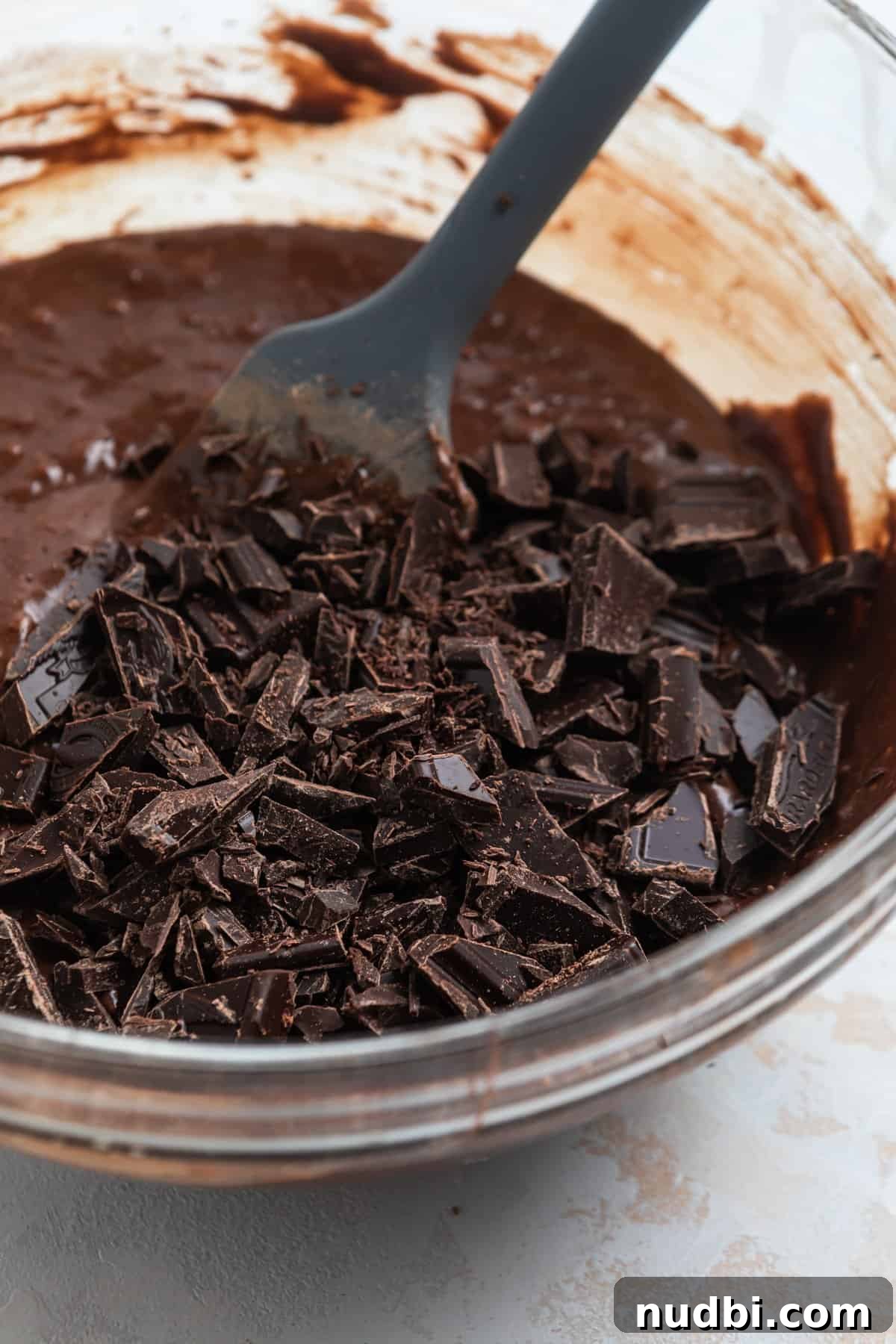 Fudgy Condensed Milk Brownies Recipe with Glossy Caramel Top 7 Chopped dark chocolate added to brownie batter with condensed milk.