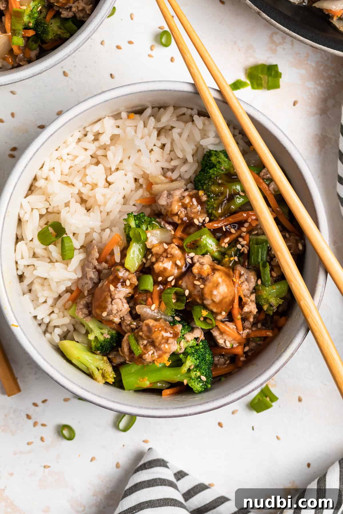 Savory Teriyaki Ground Pork Stir-Fry with Vegetables 11 Overhead view of bowl with ground pork stir fry with chopsticks propped on bowl.