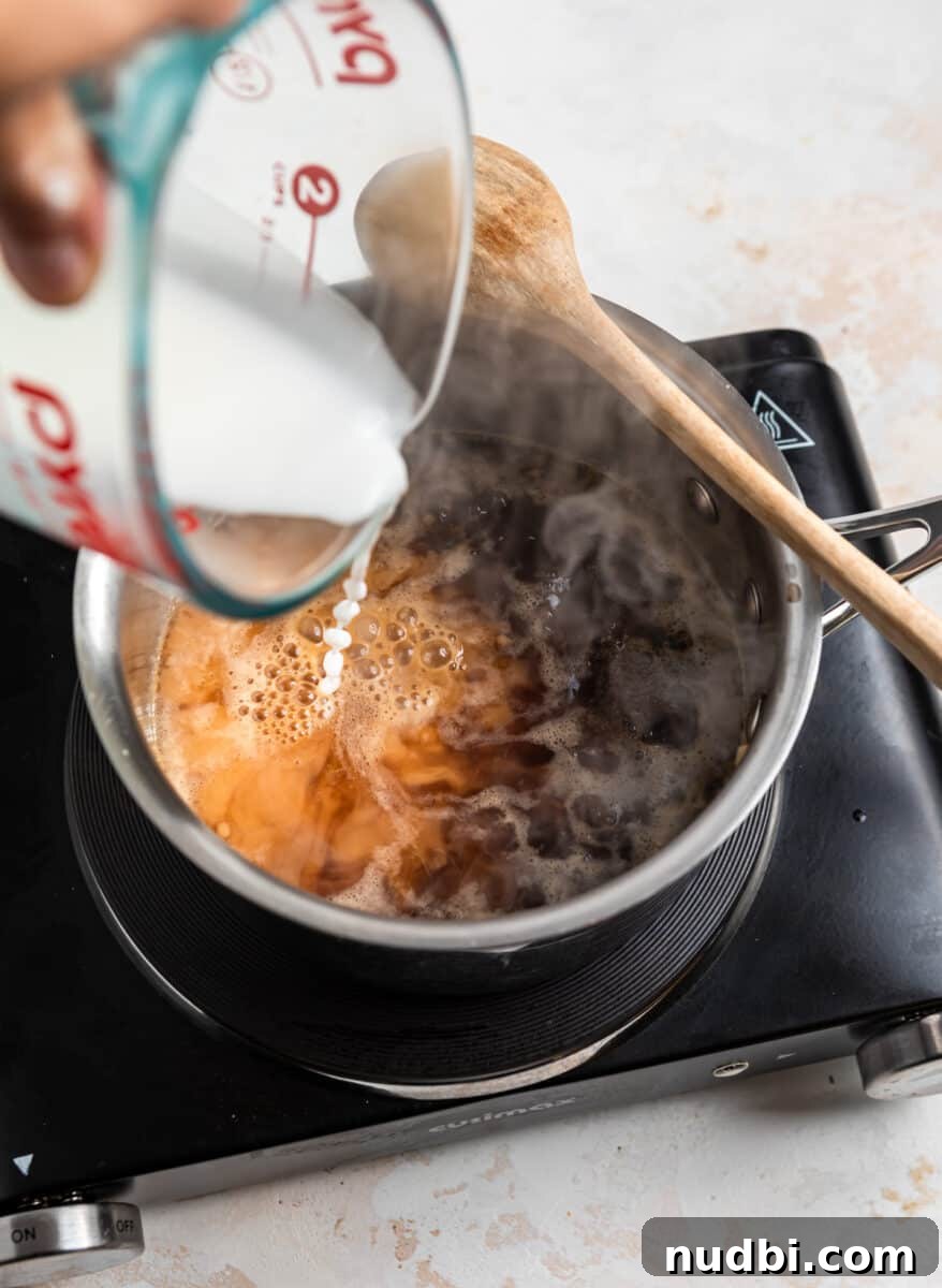 Savory Teriyaki Ground Pork Stir-Fry with Vegetables 5 Corn starch slurry being poured into sauce pan.
