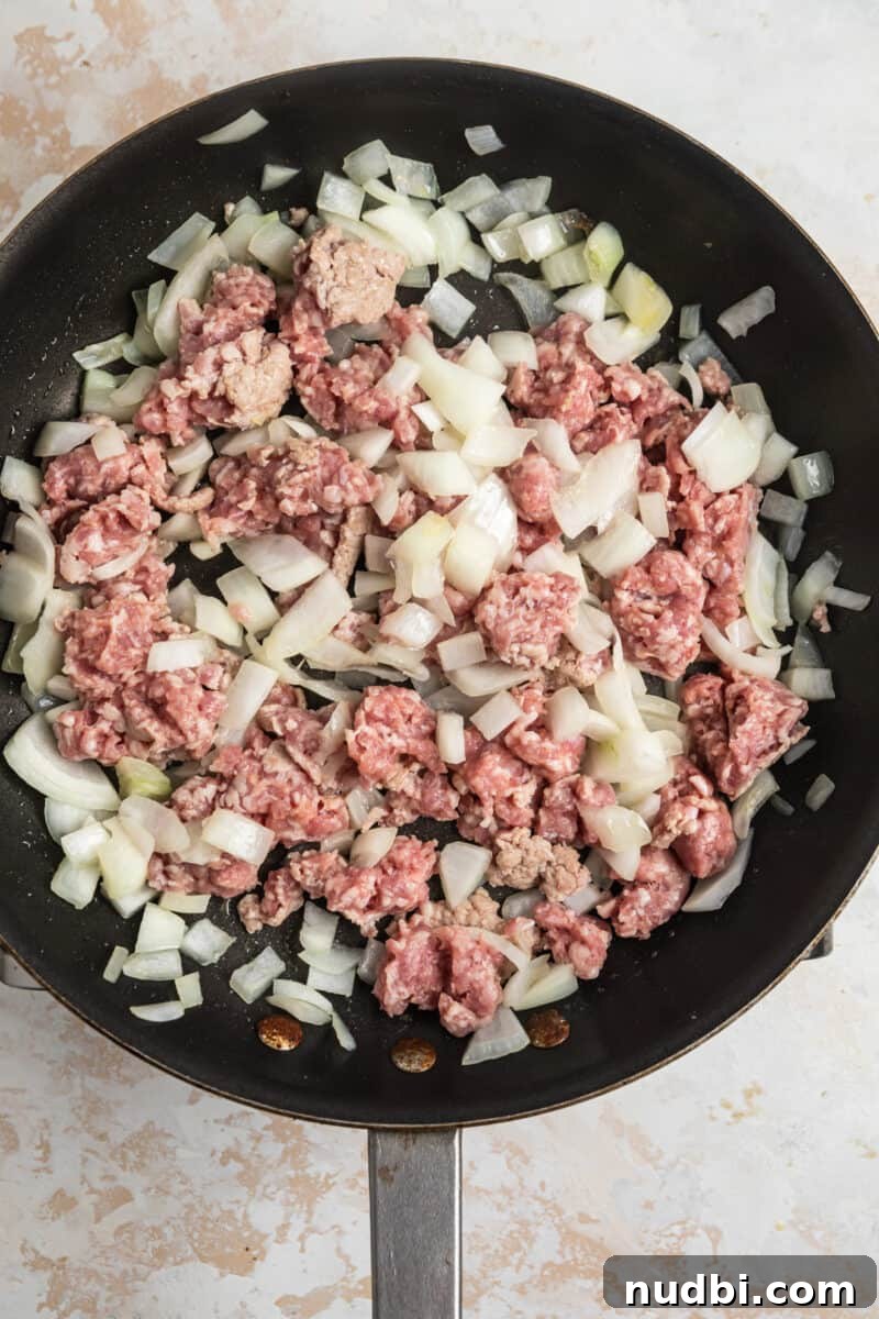 Savory Teriyaki Ground Pork Stir-Fry with Vegetables 7 Ground pork in skillet with onions being cooked.