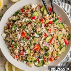 Cucumber Quinoa Salad with Feta and Lemon-Dill Dressing 7 Cucumber quinoa salad in bowl with peppers, feta, chopped dill and serving utensils.