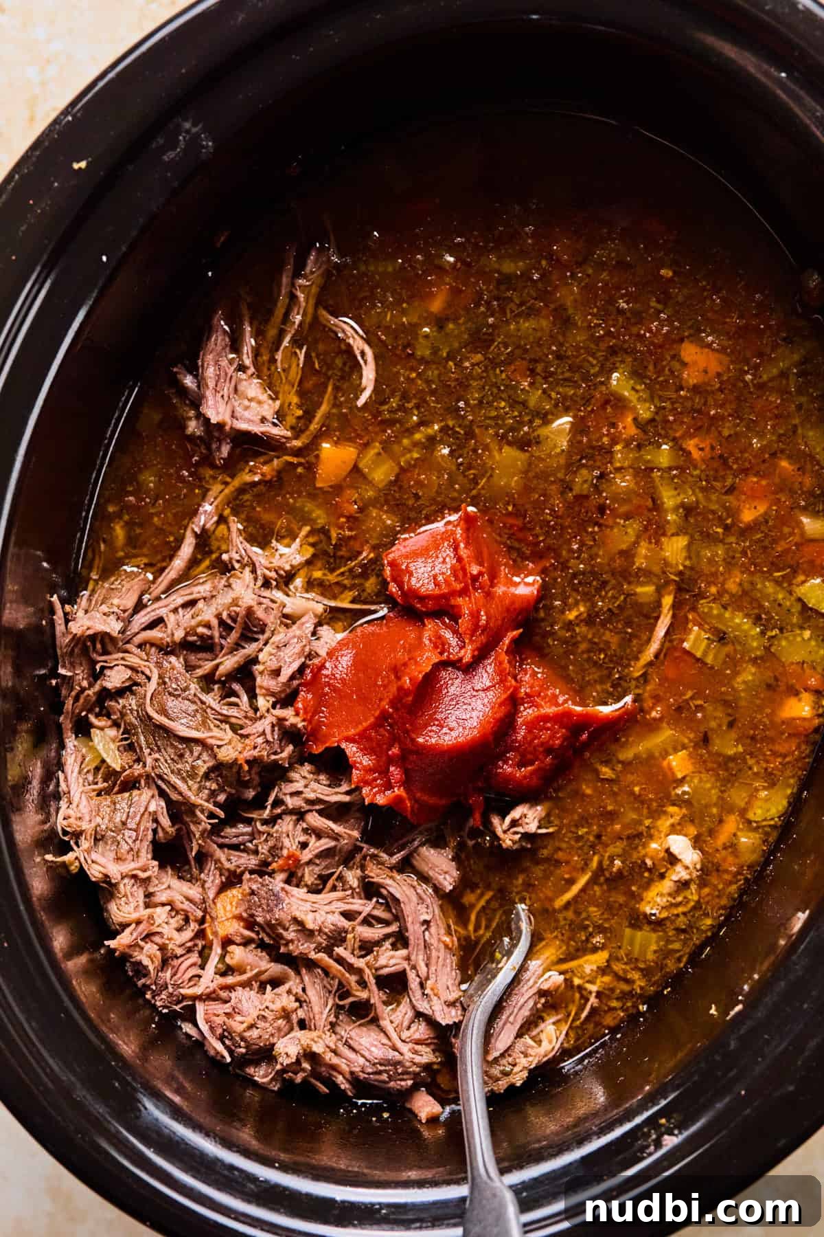 Slow-Cooked Short Rib Ragu Recipe for Tender Pasta Nights 9 Shredded meat and tomato paste added to crockpot.