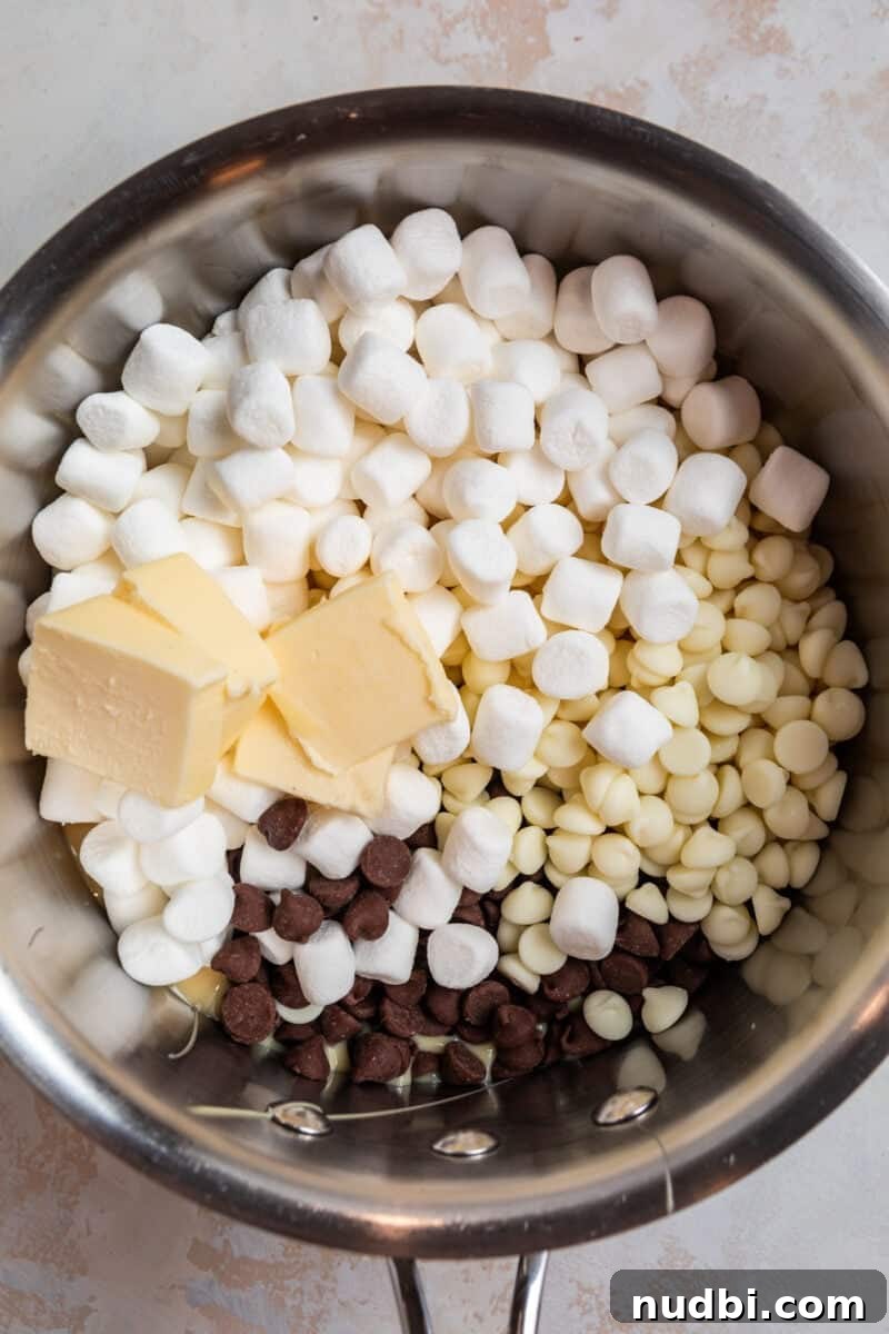Decadent Red Velvet Oreo Fudge Recipe for Chocolate Lovers 4 Marshmallows, butter, chocolate chips and sweetened condensed milk in sauce pan.