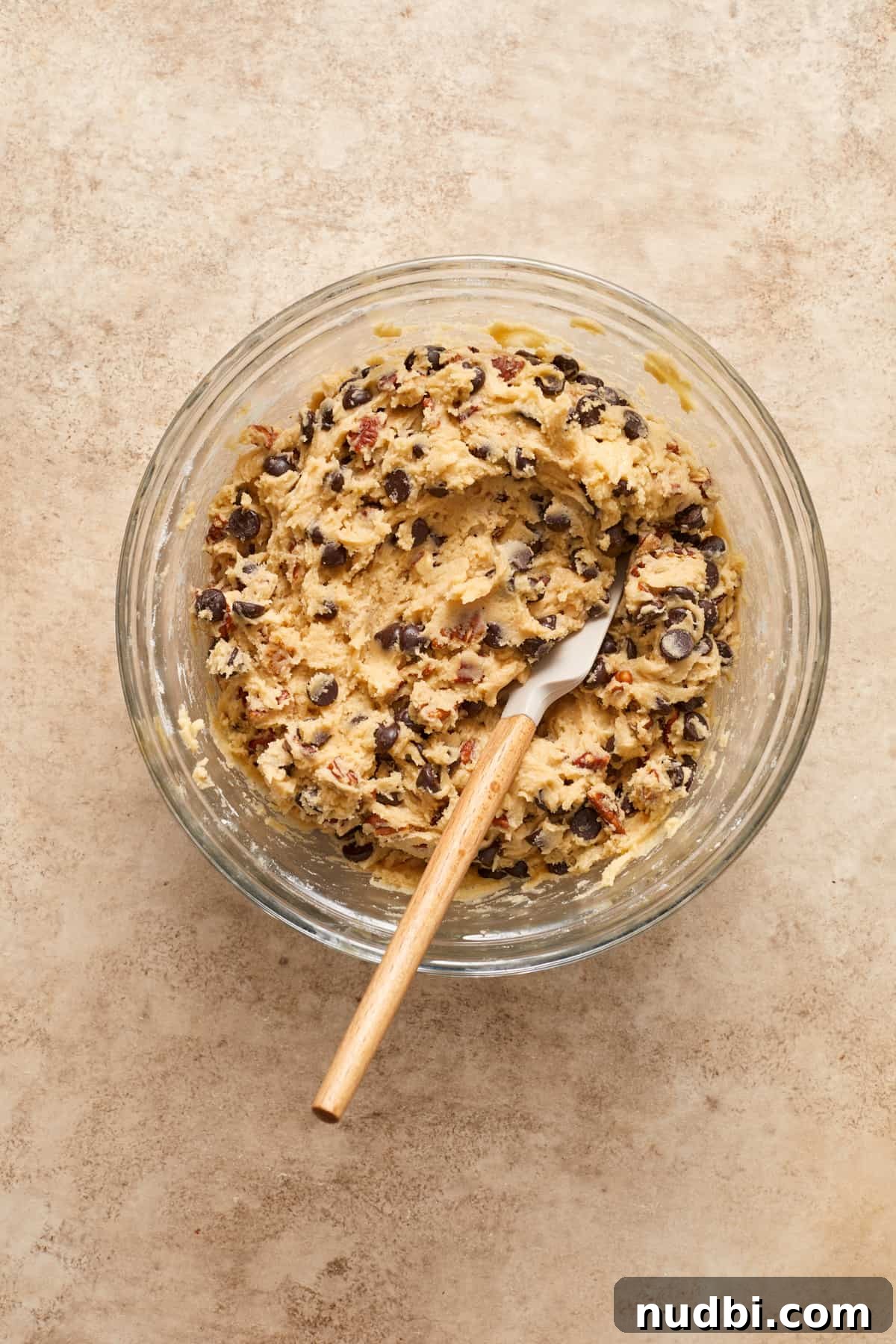 Chewy Chocolate Chip Pecan Cookies Recipe 7 Chocolate chip pecan cookies dough in bowl with spatula.