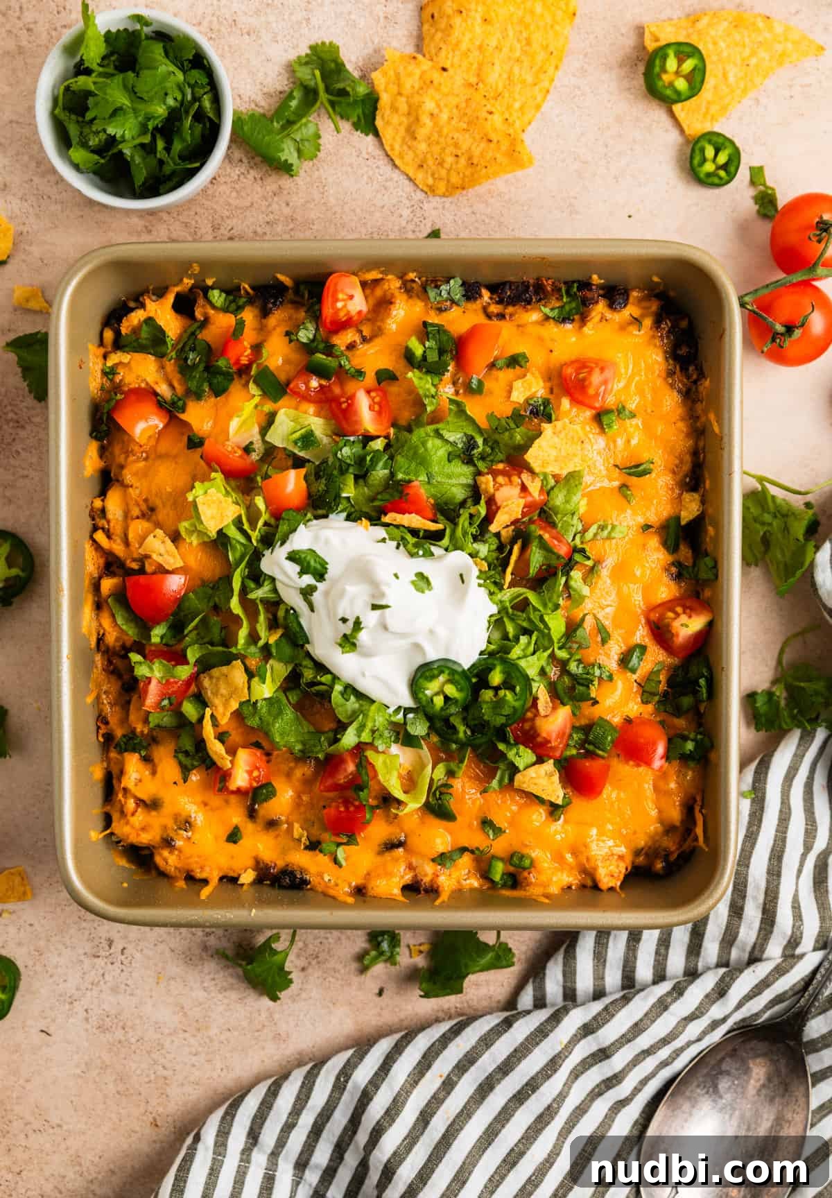 Cheesy Chicken Taco Casserole Bake with Crispy Tortilla Topping 7 Baking pan with chicken taco casserole topped with taco toppings.