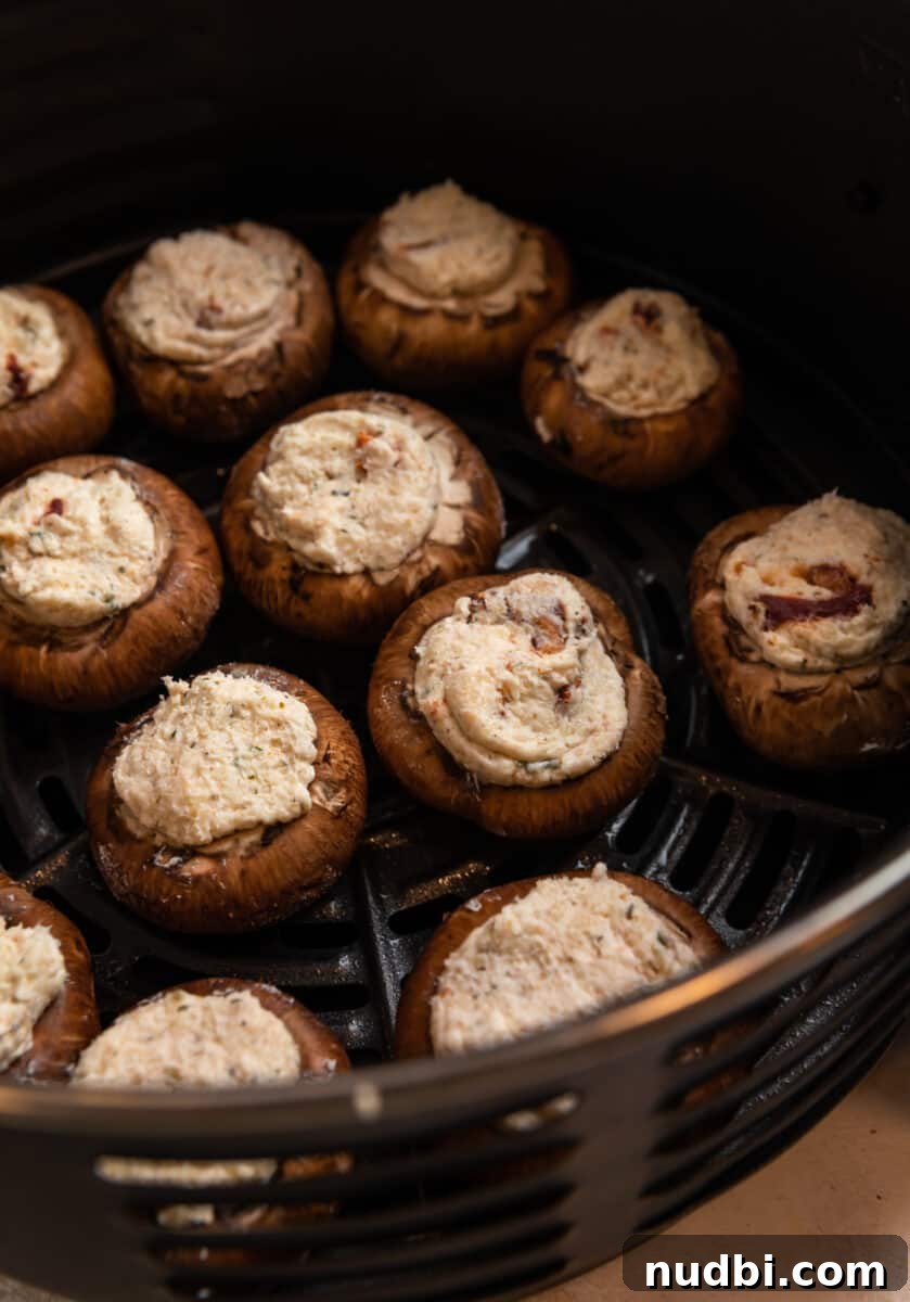 Crispy Air Fryer Stuffed Mushrooms Recipe for Quick Appetizers 6 Stuffed mushrooms in air fryer before cooked.