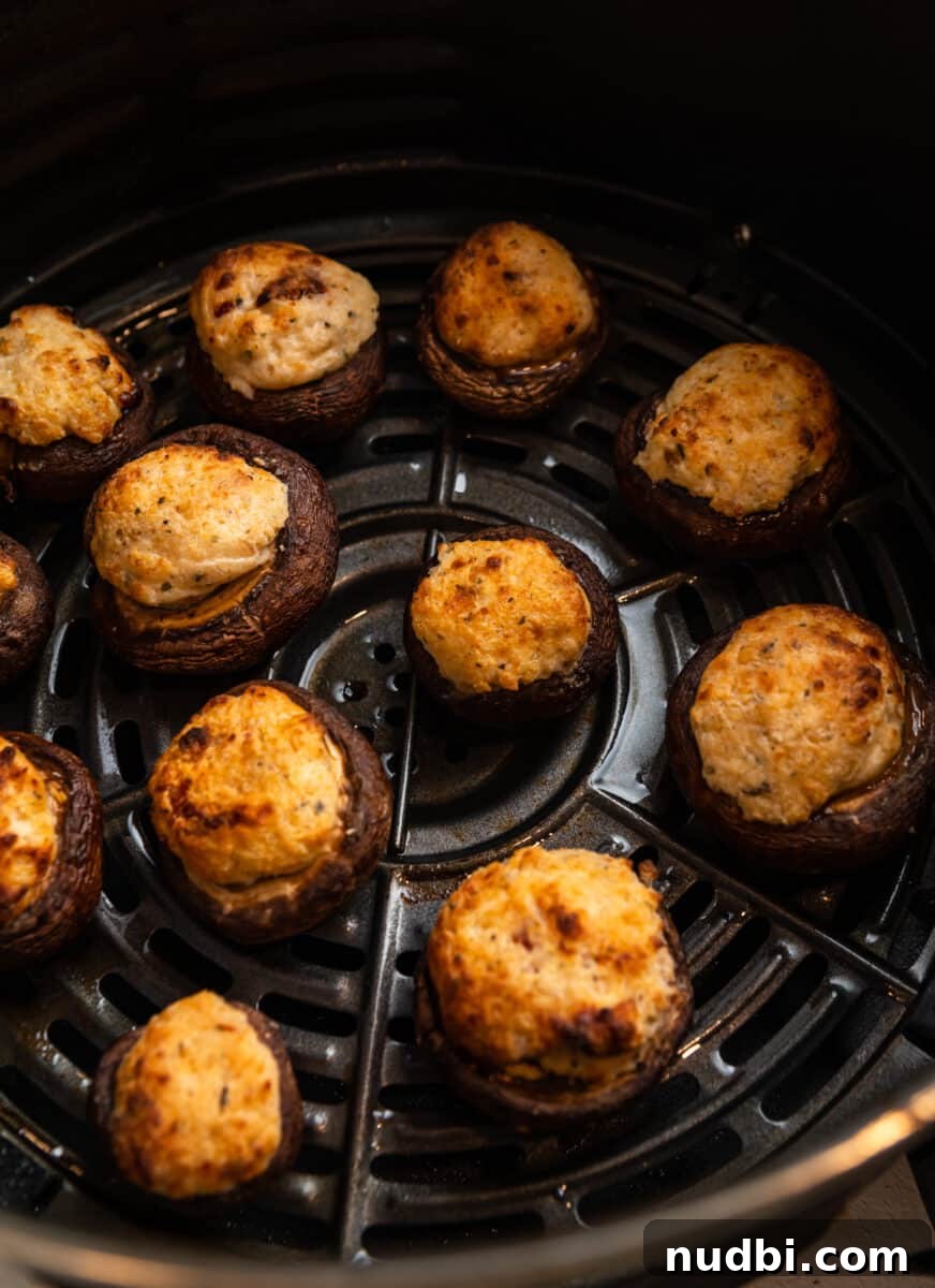 Crispy Air Fryer Stuffed Mushrooms Recipe for Quick Appetizers 7 Air fryer mushrooms in air fryer basket after cooking.