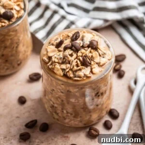 Vanilla cold brew coffee overnight oats in jar with spoon beside it and napkin behind.