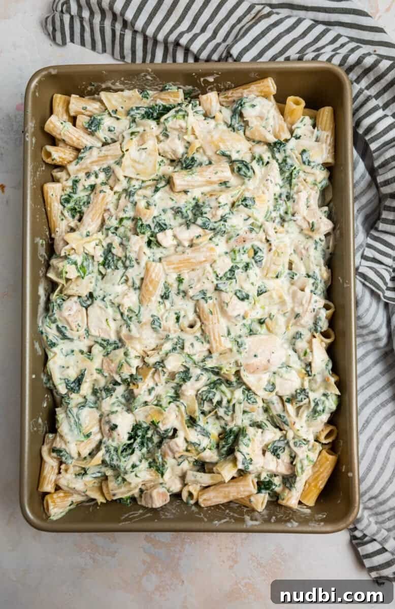 Spinach and Artichoke Chicken Casserole Recipe 8 Pan with chicken, spinach and artichoke casserole before baking.