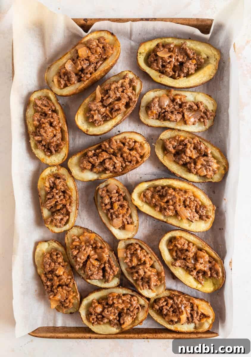 Cheeseburger-Stuffed Potato Skins: Loaded Appetizer Recipe 9 Potato skins with cheeseburger mixture stuffed inside.