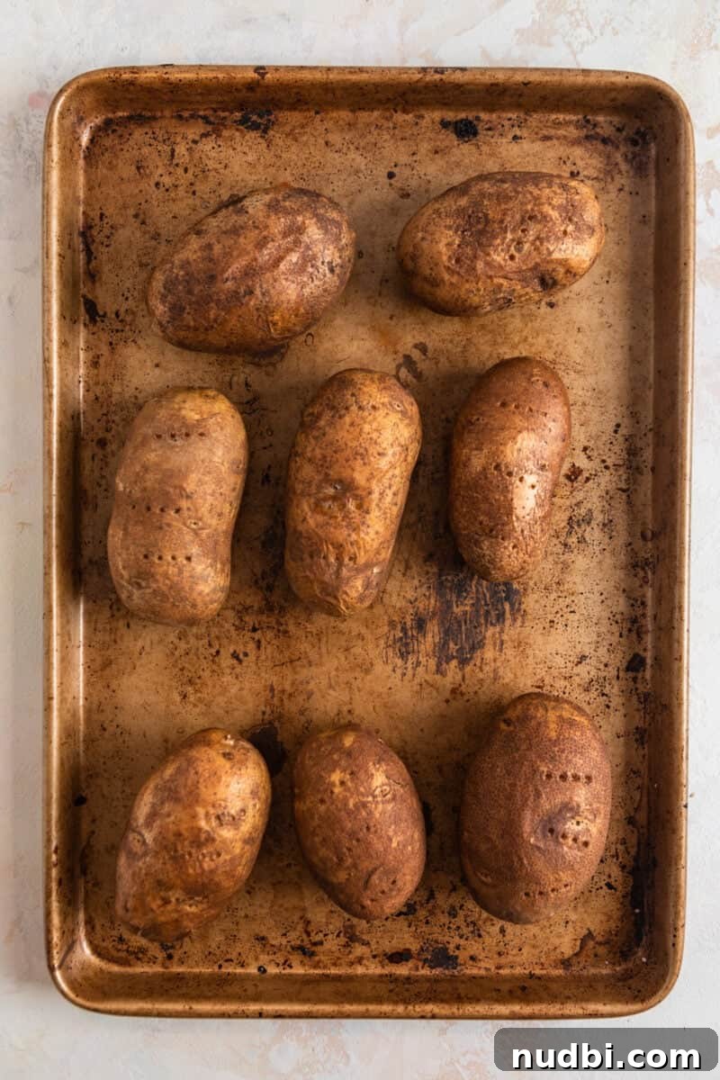 Cheeseburger-Stuffed Potato Skins: Loaded Appetizer Recipe 4 Potatoes baked on a sheet pan.
