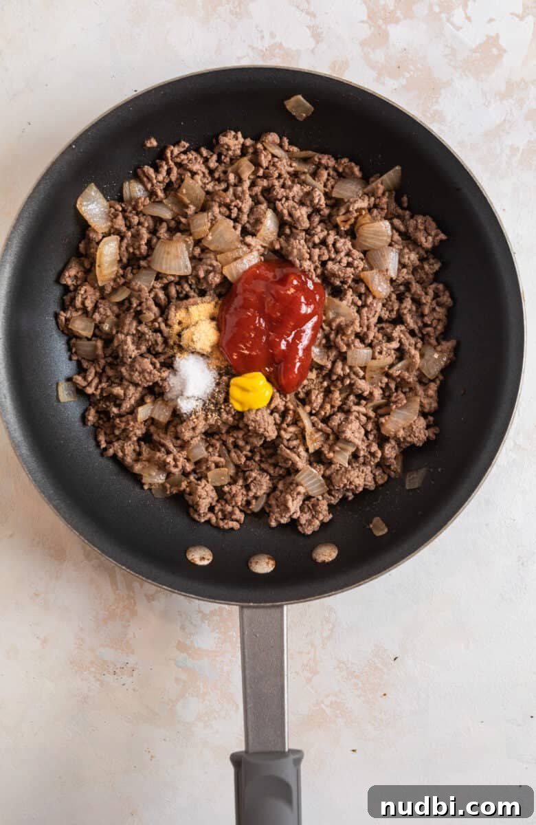 Cheeseburger-Stuffed Potato Skins: Loaded Appetizer Recipe 7 Ground beef browned in skillet with ketchup, mustard and seasoning.