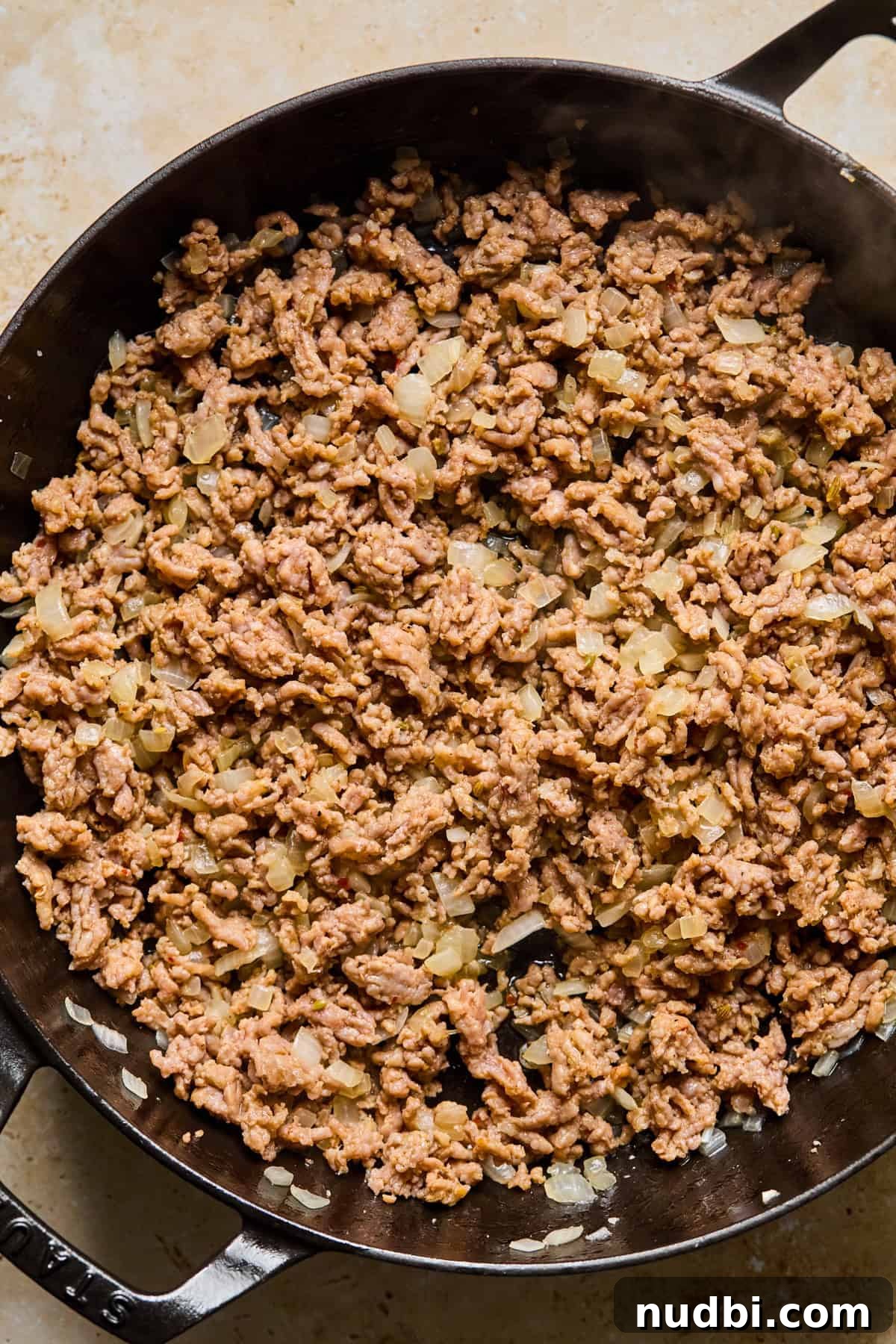 Creamy Spicy Italian Sausage Pasta with Sun-Dried Tomatoes 5 Browned sausage and onions in skillet.