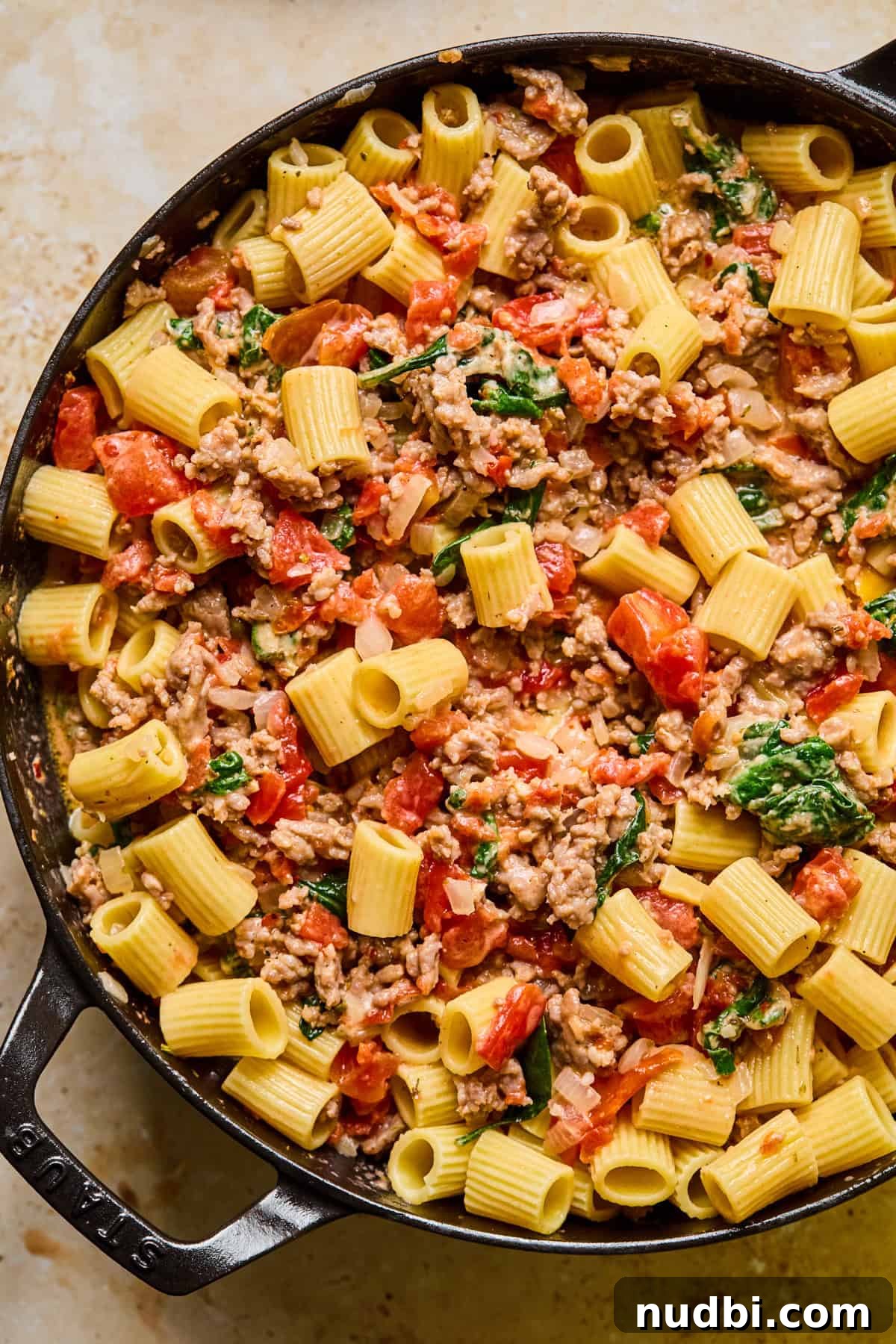 Creamy Spicy Italian Sausage Pasta with Sun-Dried Tomatoes 9 Italian sausage pasta in cast iron skillet.