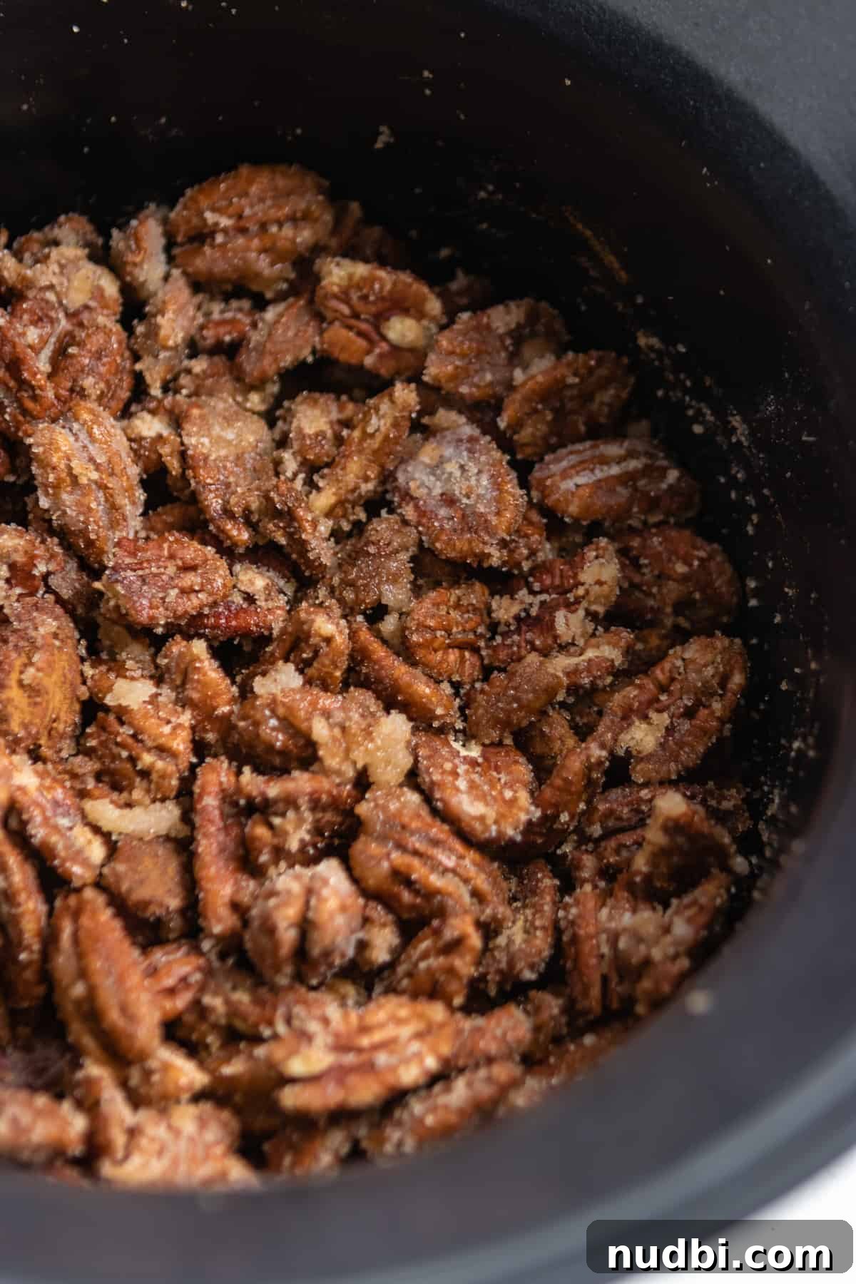 Candied Pumpkin Spice Pecans Made in a Slow Cooker 5 Cinnamon sugar coated pecans in slow cooker.