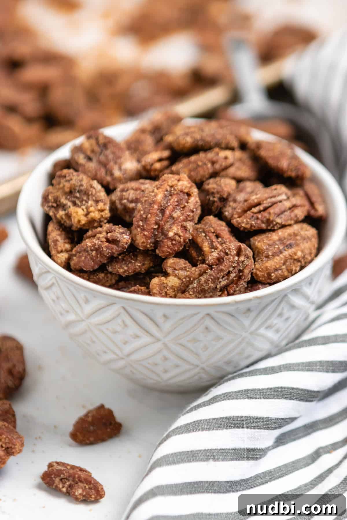 Candied Pumpkin Spice Pecans Made in a Slow Cooker 7 White bowl with candied pecans.