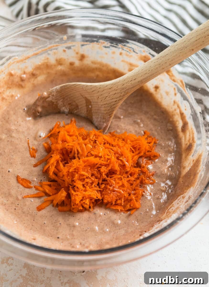 Carrot Cake Donuts with Cream Cheese Glaze: Moist Spiced Recipe 4 Shredded carrots in mixing bowl with carrot cake donut mixture.