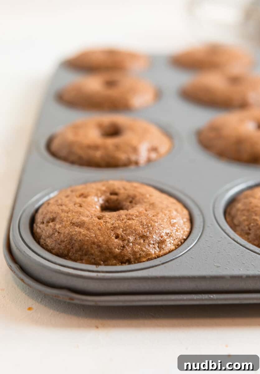 Carrot Cake Donuts with Cream Cheese Glaze: Moist Spiced Recipe 6 Carrot cake baked donuts in donut pan.