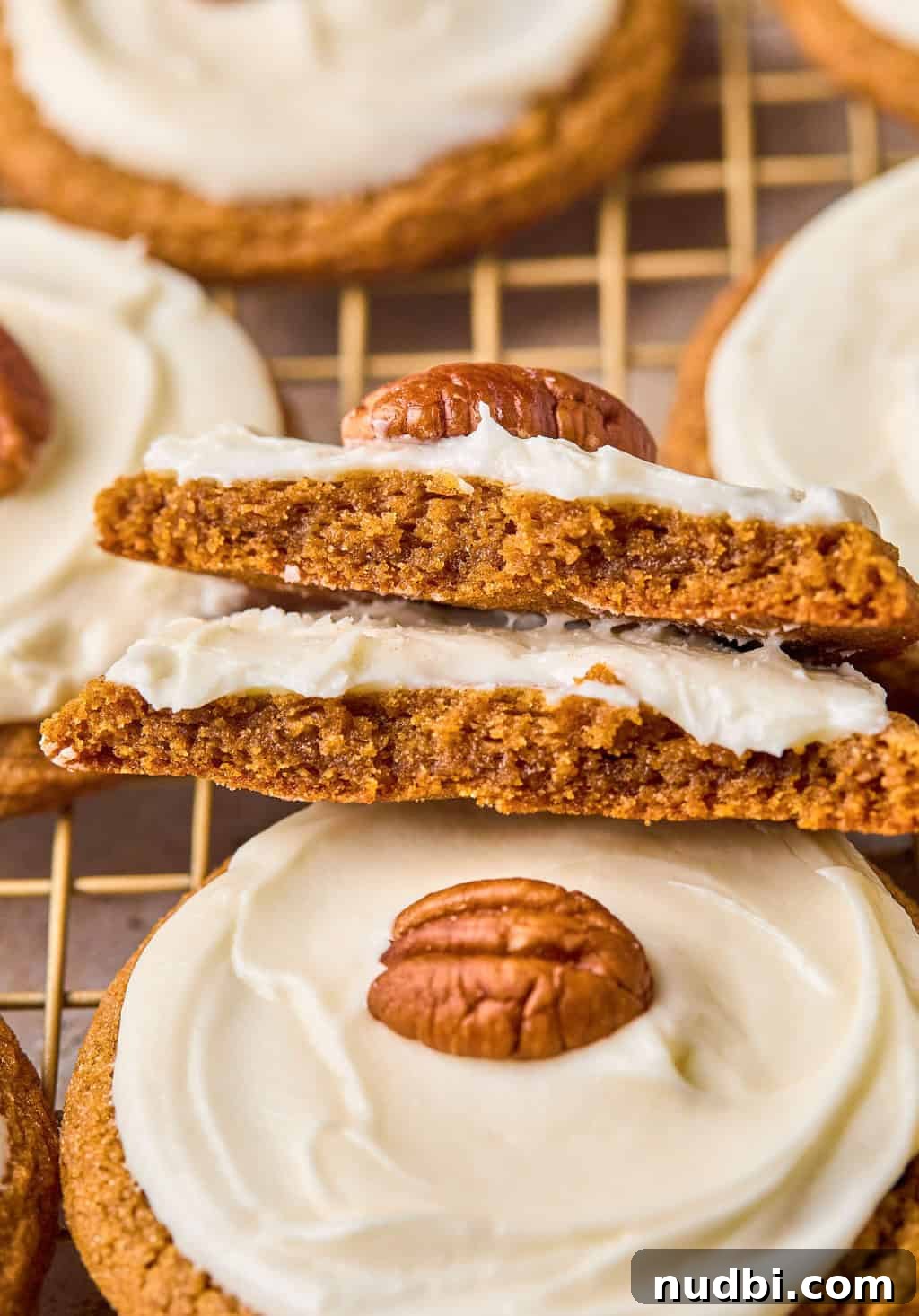 Pumpkin Spice Molasses Cookies Recipe with Warm Autumn Flavor 16 Pumpkin cookies broken in half and stacked.