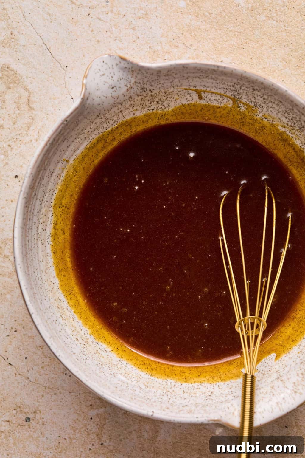 Pumpkin Spice Molasses Cookies Recipe with Warm Autumn Flavor 5 Whisked molasses cookie wet ingredients with whisk propped in it.