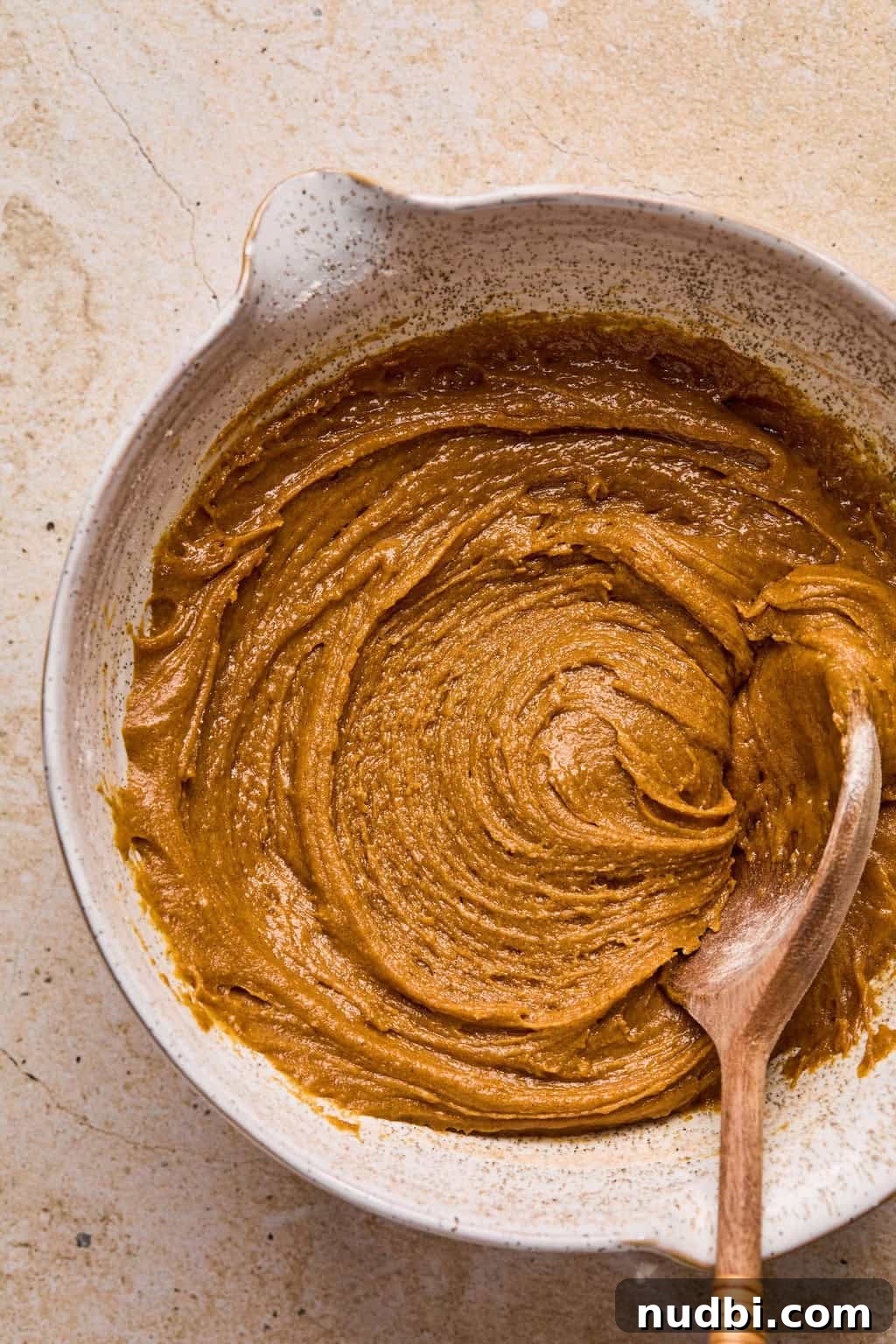 Pumpkin Spice Molasses Cookies Recipe with Warm Autumn Flavor 8 Molasses cookie dough mixed in bowl with wooden spoon.