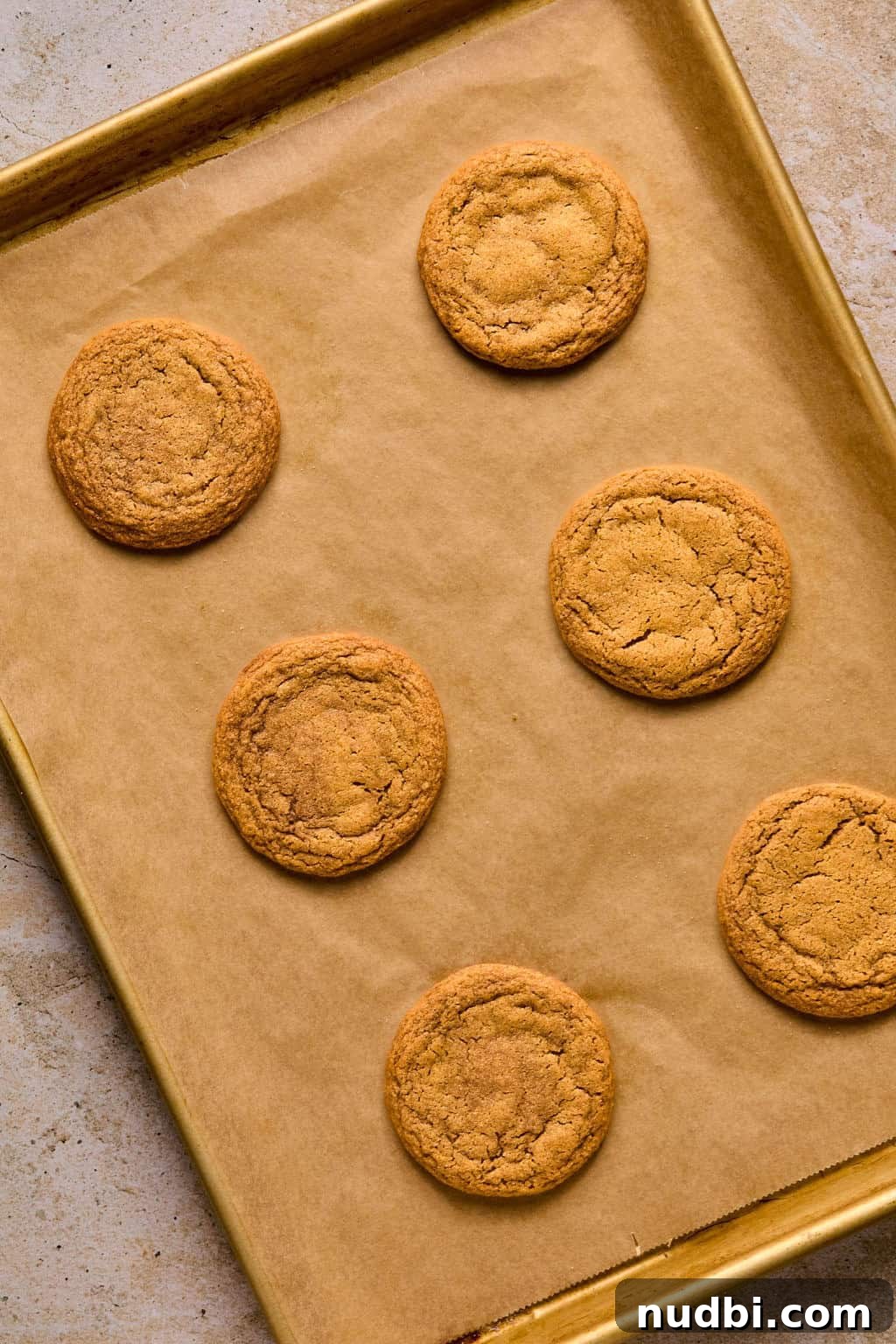 Pumpkin Spice Molasses Cookies Recipe with Warm Autumn Flavor 10 Baked pumpkin molasses cookies on baking sheet.