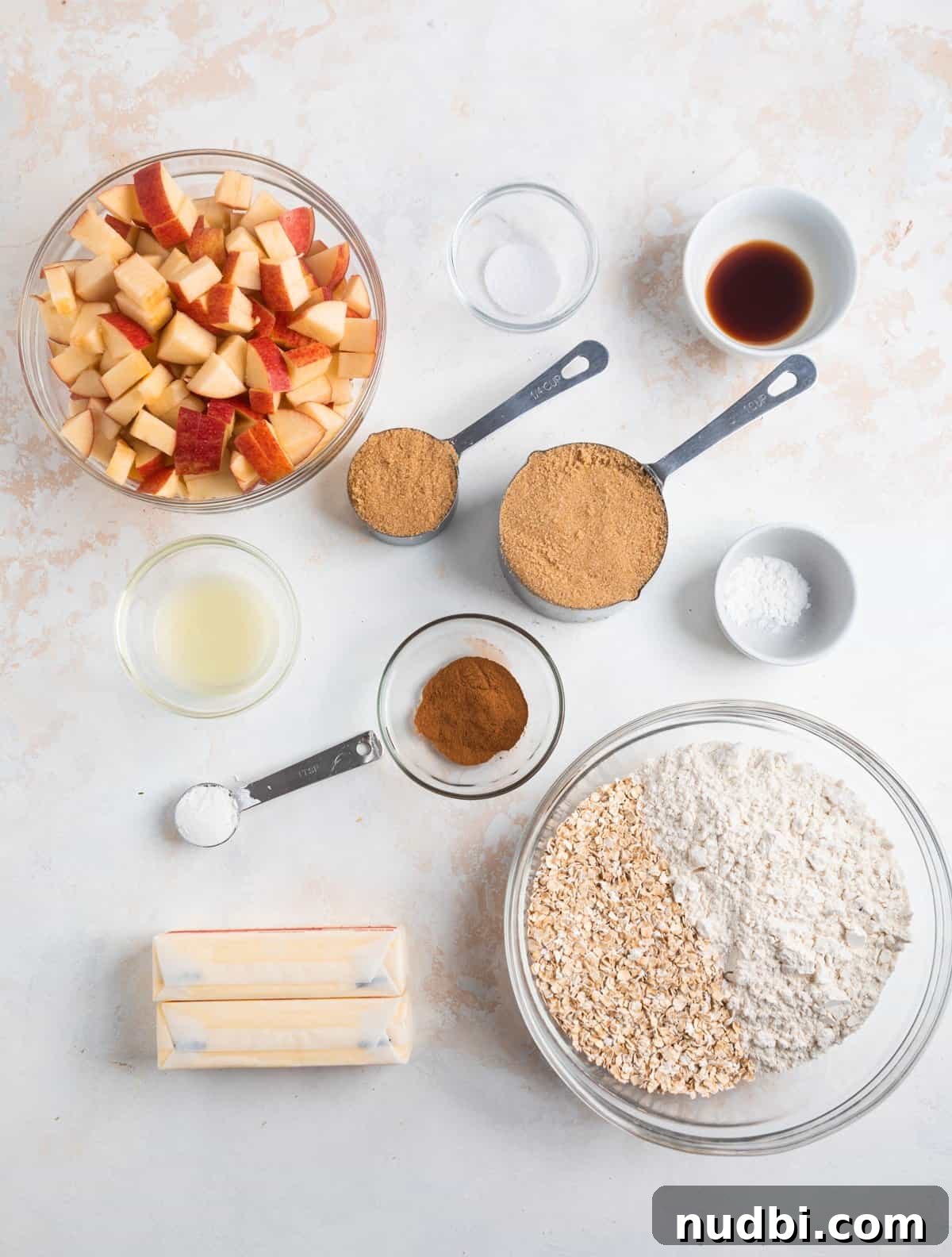 Homemade Apple Crumble Bars Recipe — Soft Filling & Crunchy Topping 3 Oats, flour, cinnamon, butter and other ingredients on counter for recipe.