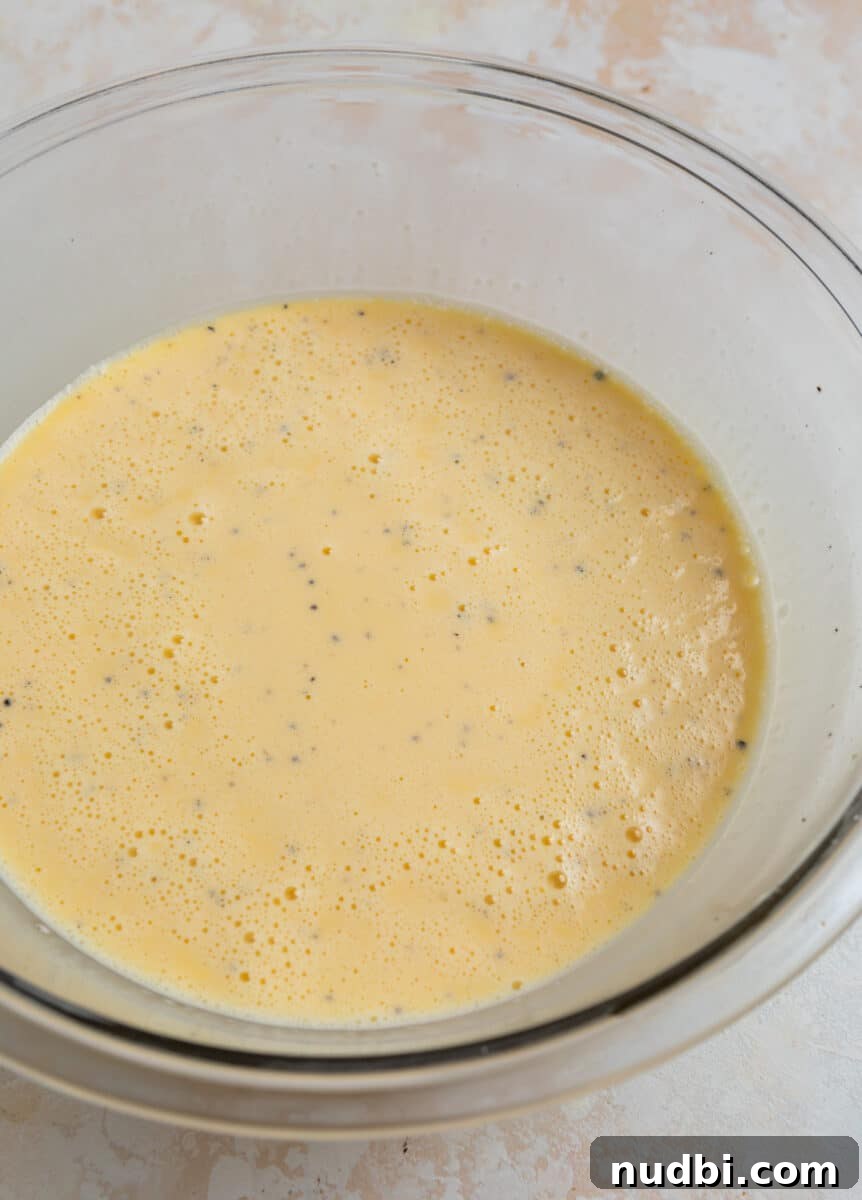 Savory Crustless Mushroom and Cheese Quiche Recipe 6 Eggs, cream and milk whisked in mixing bowl.