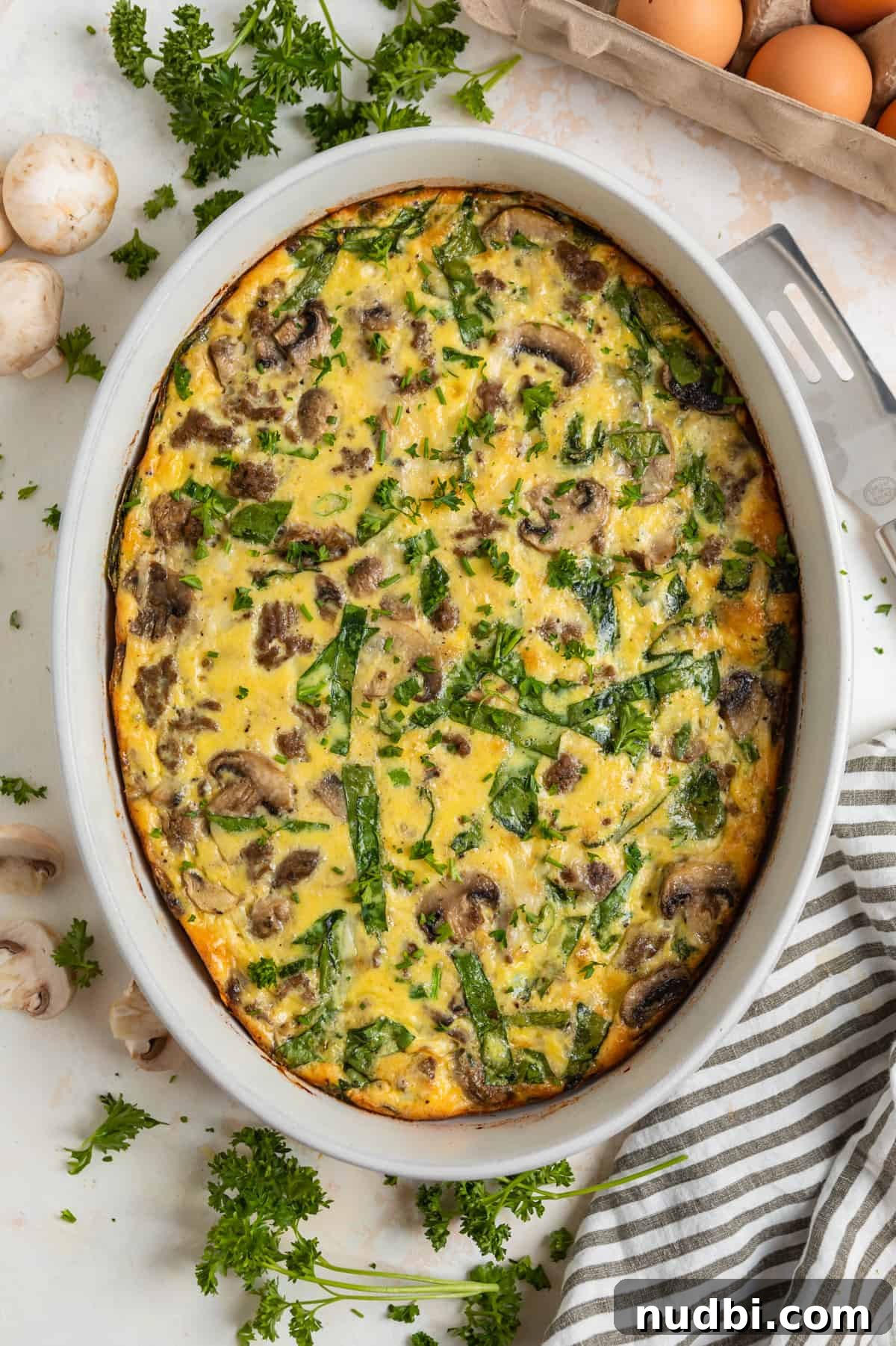 Savory Crustless Mushroom and Cheese Quiche Recipe 9 Mushroom swiss quiche with spinach and ground beef baked in casserole dish.
