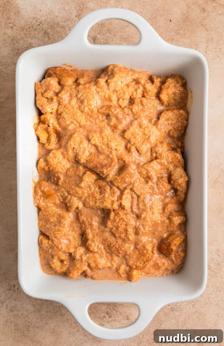 Pumpkin Spice French Toast Casserole Recipe for Fall Brunch 6 French toast casserole mixture in greased white pan.