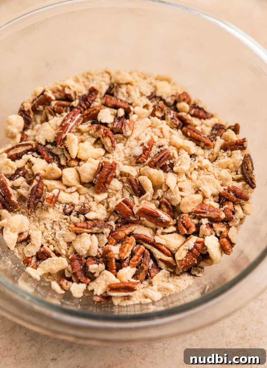 Pumpkin Spice French Toast Casserole Recipe for Fall Brunch 8 Pecans and buttery flour mixture in bowl.