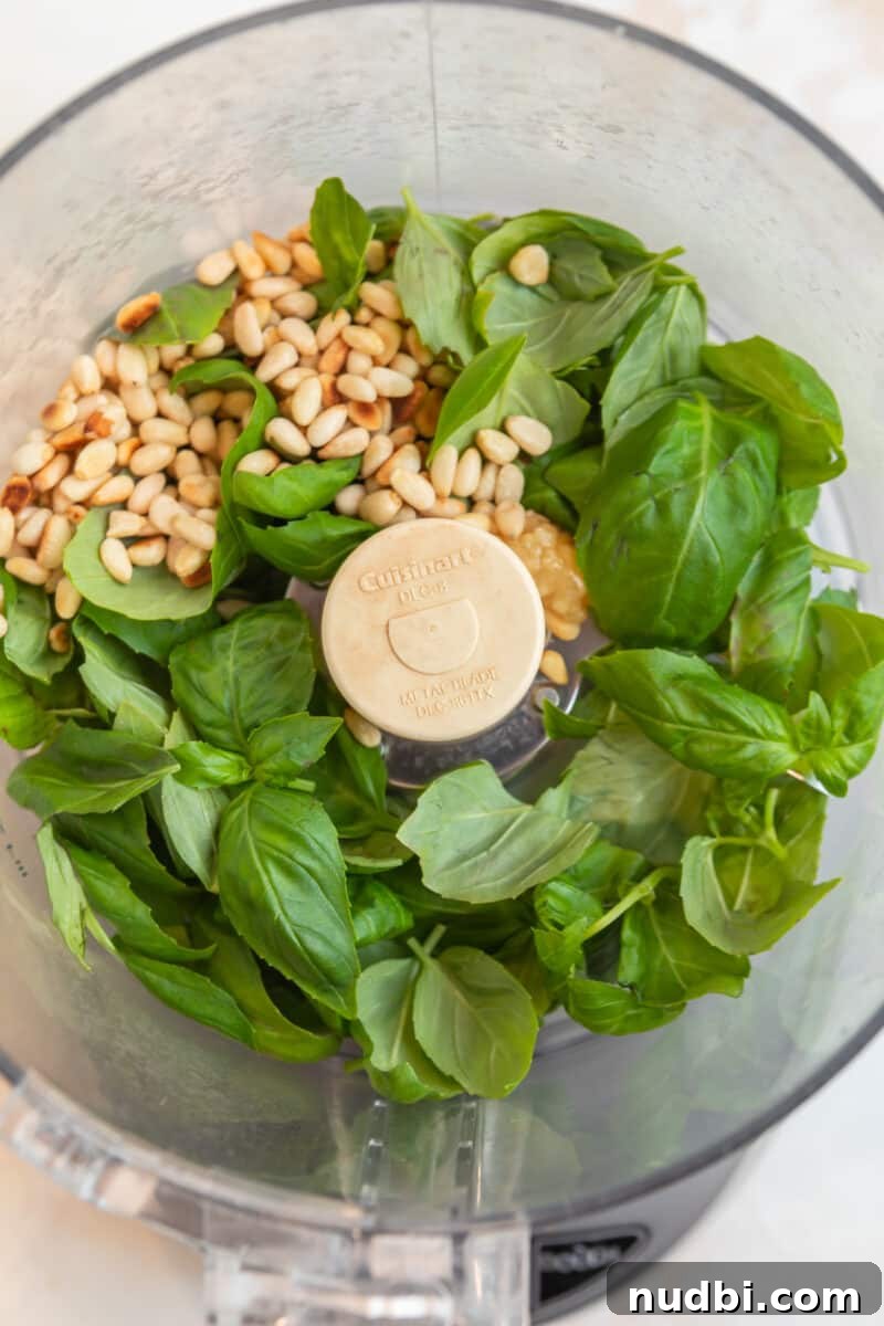 Creamy Pesto Orzo Salad with Cherry Tomatoes and Basil 4 Basil, pine nuts, and garlic in food processor.