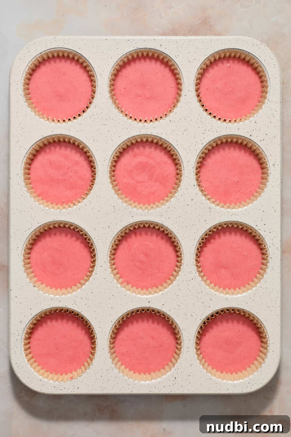 Strawberry Crunch Cupcakes with Crunchy Topping and Cream Cheese Frosting 6 Cupcake liners filled with strawberry cupcake batter before baking.