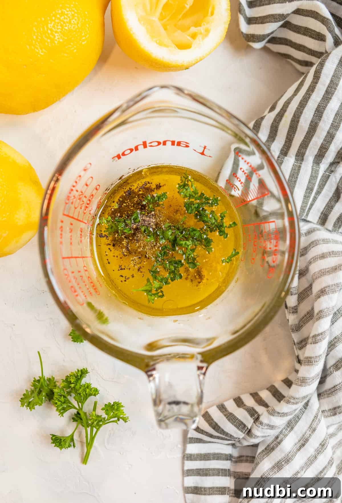 Zesty Lemon Dijon Salad Dressing Recipe 4 Measuring cup with honey lemon dijon dressing ingredients before whisking.