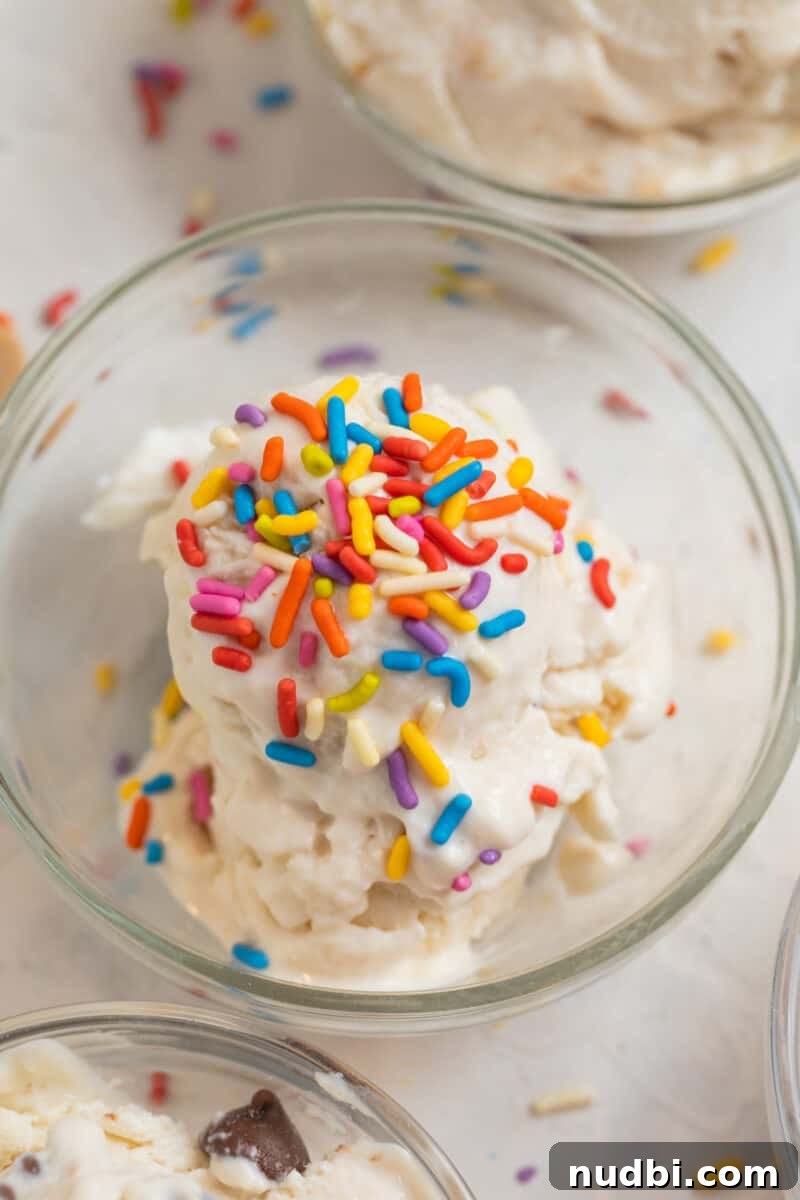 Creamy Cottage Cheese Ice Cream Recipe — Low-Sugar Frozen Dessert 4 Vanilla cottage cheese ice cream scooped in glass bowl with rainbow sprinkles.