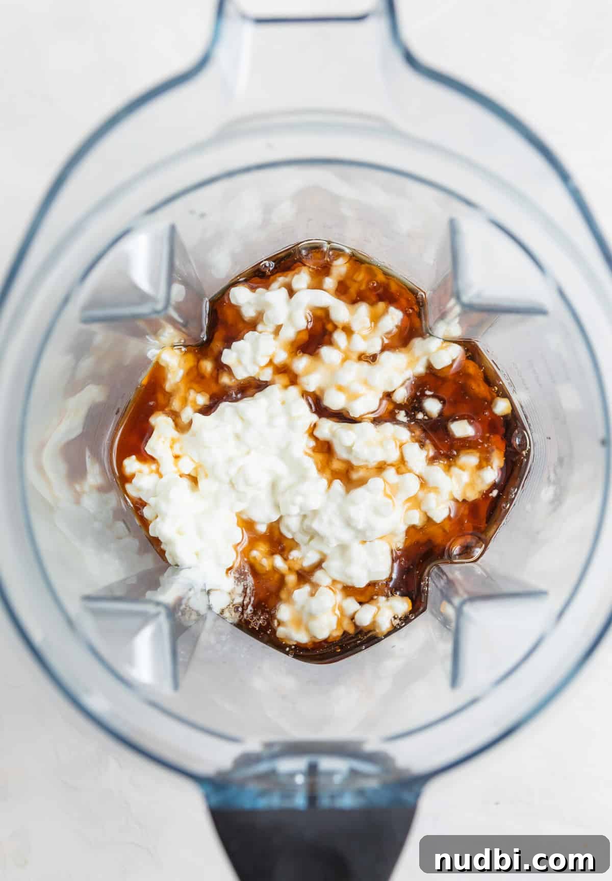 Creamy Cottage Cheese Ice Cream Recipe — Low-Sugar Frozen Dessert 9 Cottage cheese, maple syrup, vanilla and sea salt in Vitamix blender.