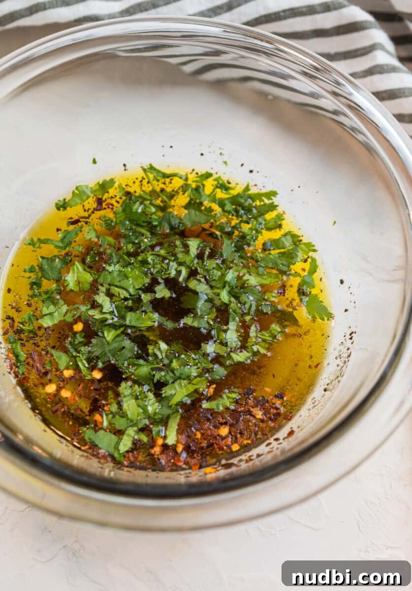 Grilled Flank Steak Salad with Chimichurri and Arugula 5 Cilantro lime marinade ingredients in glass bowl.