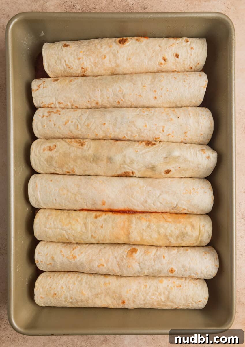 Cheesy Ground Turkey Enchiladas with Homemade Red Sauce 11 Pan with prepped enchiladas before baking.