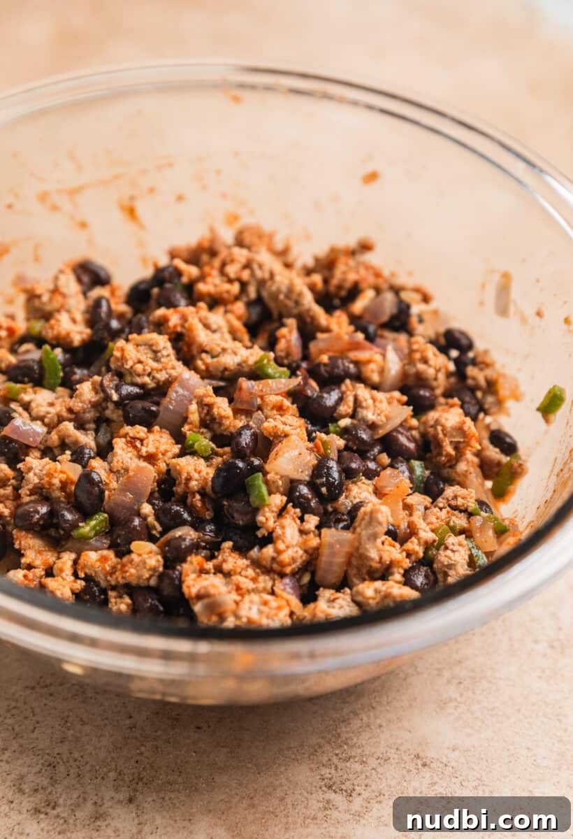 Cheesy Ground Turkey Enchiladas with Homemade Red Sauce 6 Ground turkey black bean mixture in glass mixing bowl.