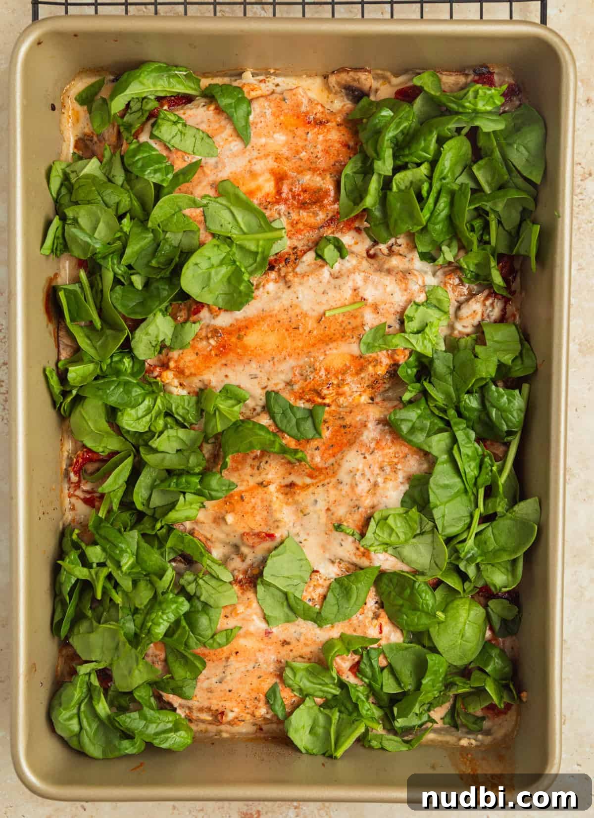 Creamy Baked Tuscan Chicken with Sun-Dried Tomatoes and Spinach 10 Spinach chopped and added to pan with creamy chicken.