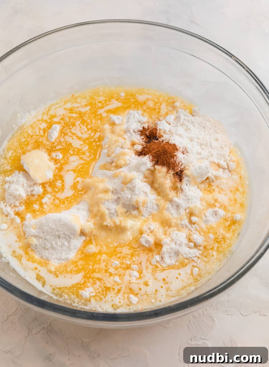 Peach Cobbler Made with Cake Mix: Quick Southern Dessert recipe 7 Butter, cake mix and cinnamon in glass mixing bowl.