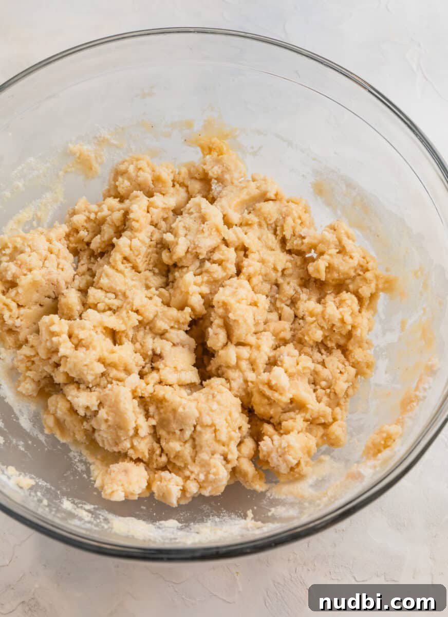 Peach Cobbler Made with Cake Mix: Quick Southern Dessert recipe 8 Cobbler topping mixed in glass mixing bowl.