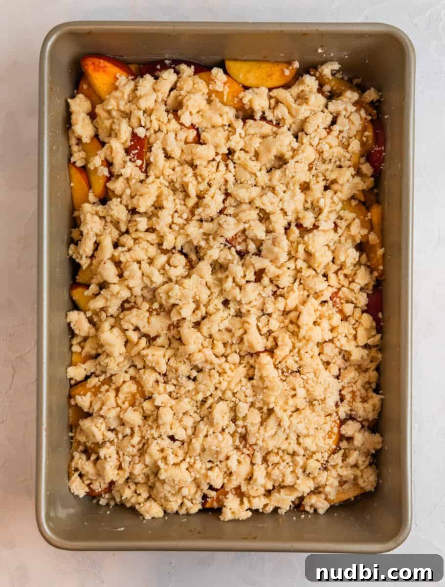Peach Cobbler Made with Cake Mix: Quick Southern Dessert recipe 9 Peach cobbler ingredients in baking pin before baking.