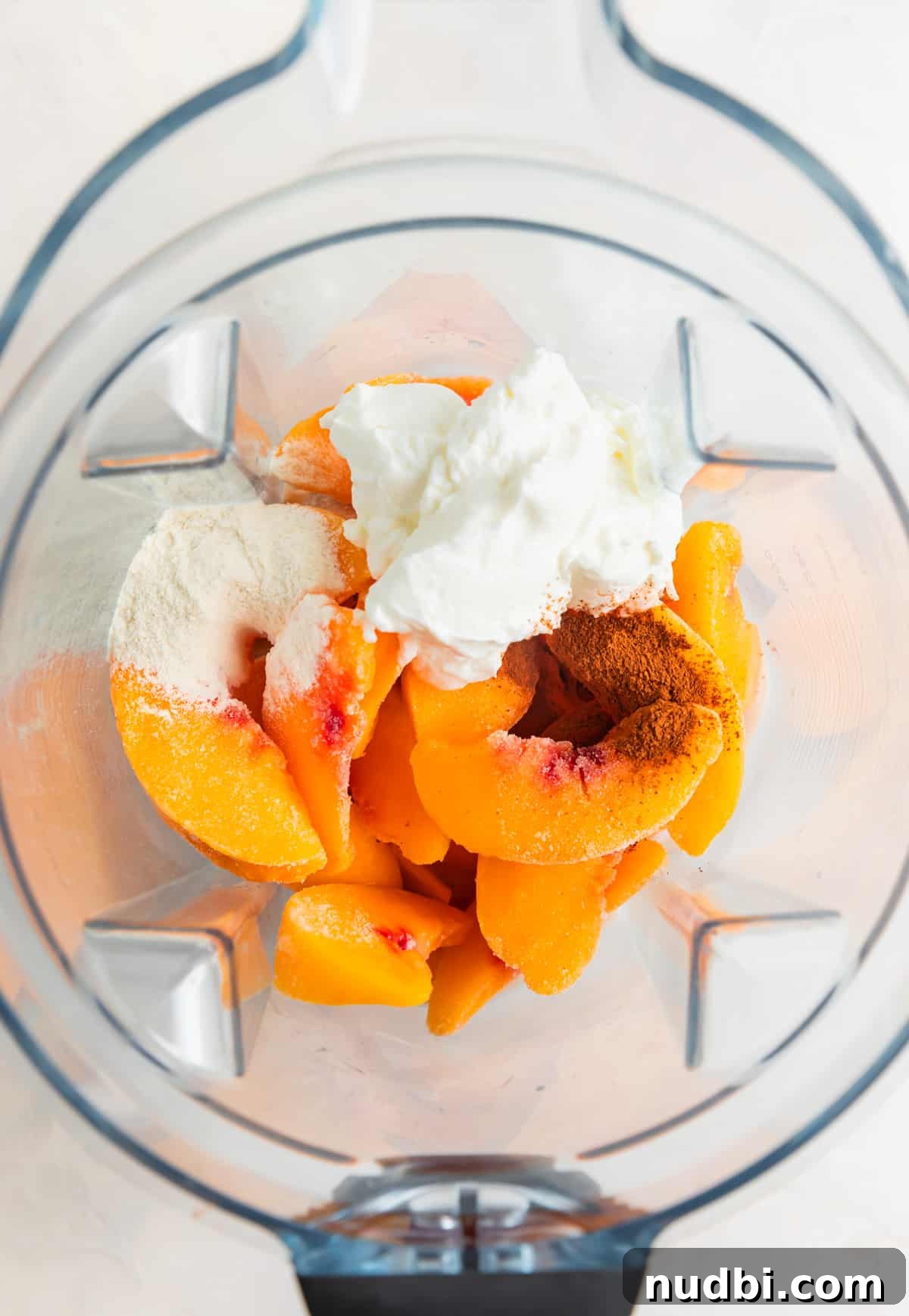 Creamy Banana and Peach Smoothie Recipe for Summer Refreshment 3 Smoothie ingredients in blender before blending.