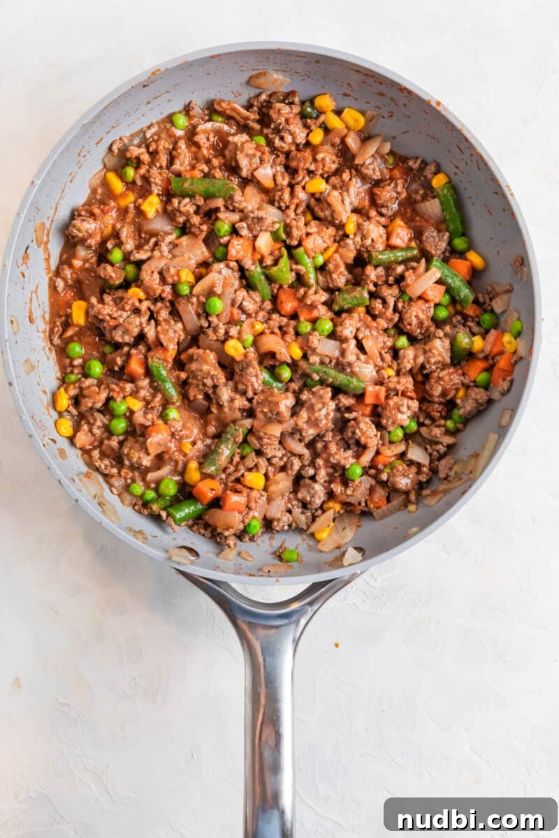Tater Tot Shepherd’s Pie Recipe: Comforting Family Meal 6 Shepherd's pie mixture cooked in skillet.